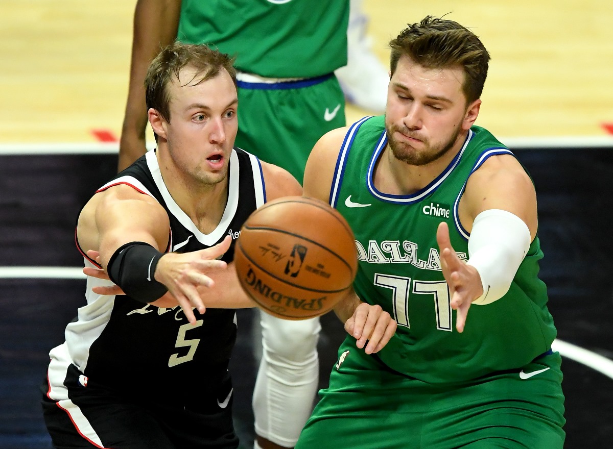 Dec 27, 2020; Los Angeles, California, USA;  Los Angeles Clippers guard Luke Kennard (5) passes the ball against Dallas Mavericks guard Luka Doncic (77) in the first quarter at Staples Center. Mandatory Credit: Jayne Kamin-Oncea-USA TODAY Sports