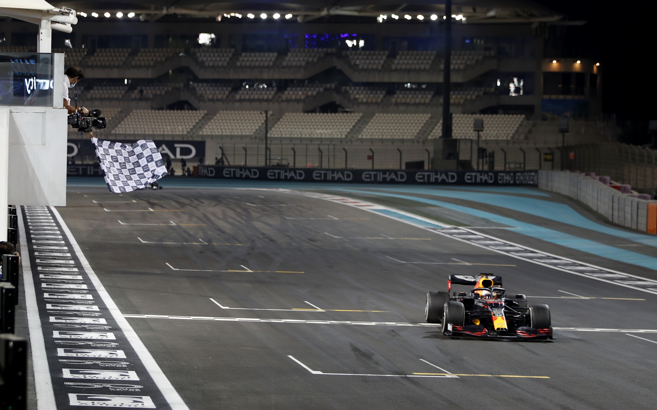 Formula One F1 - Abu Dhabi Grand Prix - Yas Marina Circuit, Abu Dhabi, United Arab Emirates - December 13, 2020 Red Bull's Max Verstappen passes the chequered flag to win the race Pool via REUTERS