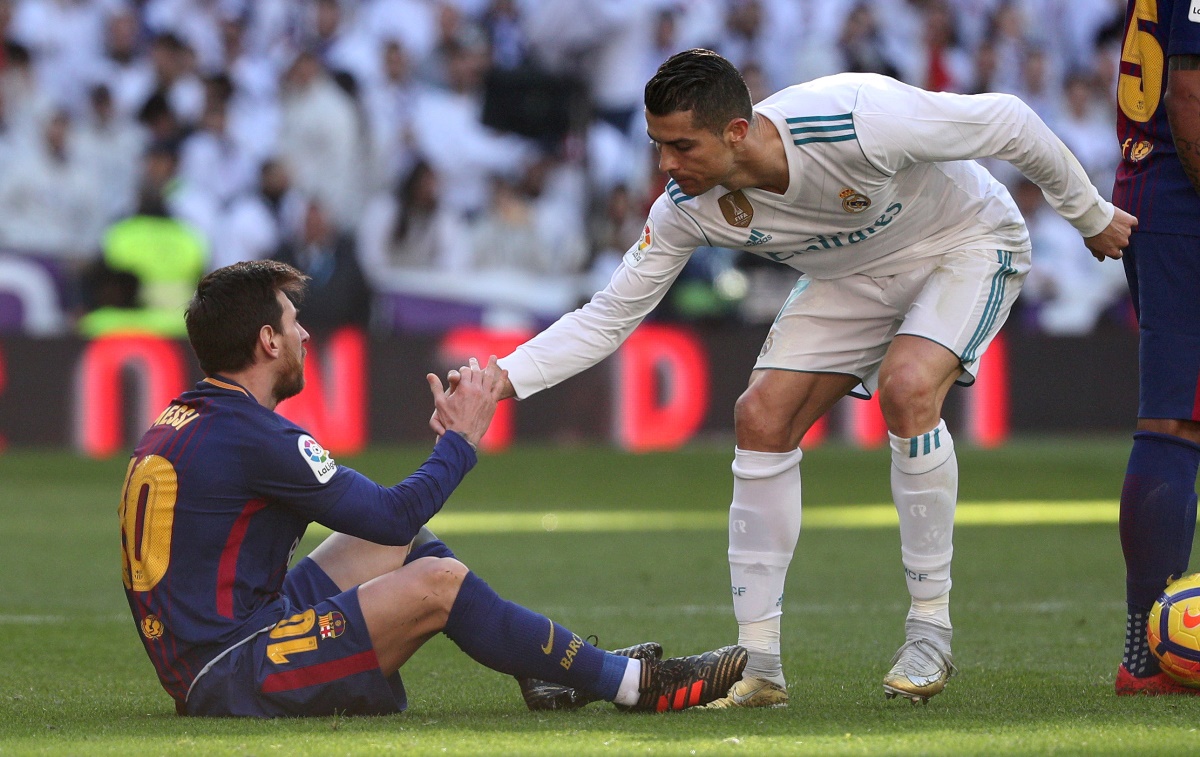 FILE PHOTO: Soccer Football - La Liga Santander - Real Madrid vs FC Barcelona - Santiago Bernabeu, Madrid, Spain - December 23, 2017   Real Madrid’s Cristiano Ronaldo helps Barcelona’s Lionel Messi get back to his feet   REUTERS