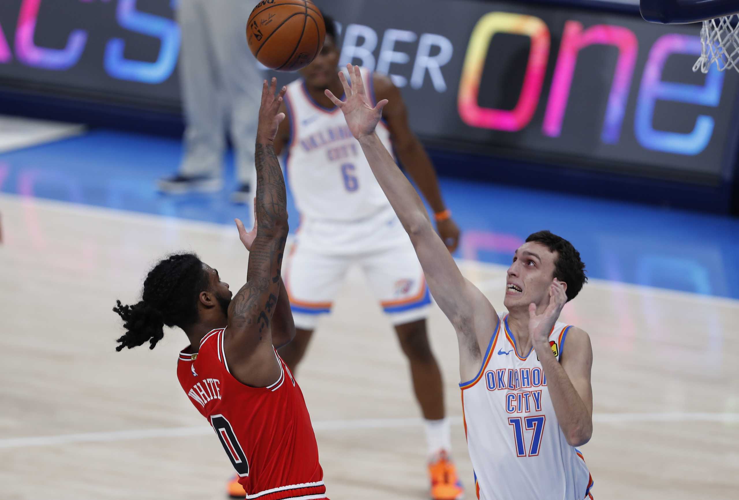 Dec 18, 2020; Oklahoma City, Oklahoma, USA; Chicago Bulls guard Coby White (0) shoots as Oklahoma City Thunder forward Aleksej Pokusevski (17) defends the shot during the first quarter at Chesapeake Energy Arena. Mandatory Credit: Alonzo Adams-USA TODAY Sports