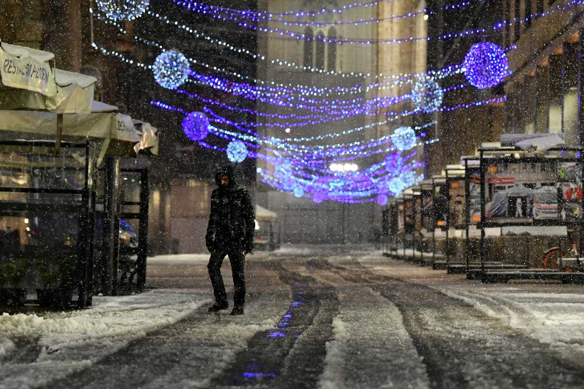 A man walks during a snowfall, in Milan, Italy December 28, 2020. REUTERS