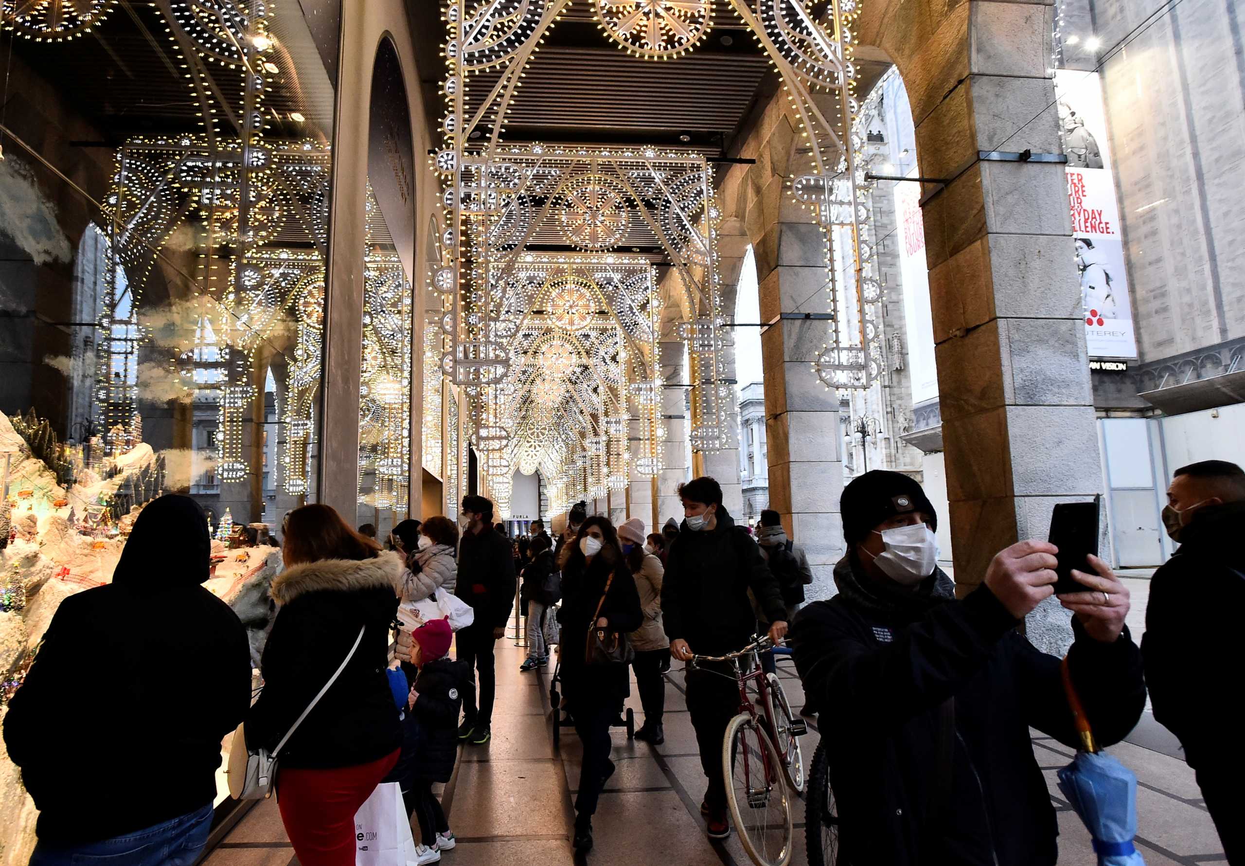 People go shopping after Lombardy was downgraded from a red to to an orange zone, loosening coronavirus disease (COVID-19) restrictions including allowing non-essential shops to re-open ahead of Christmas, in Milan, Italy, December 1, 2020. REUTERS