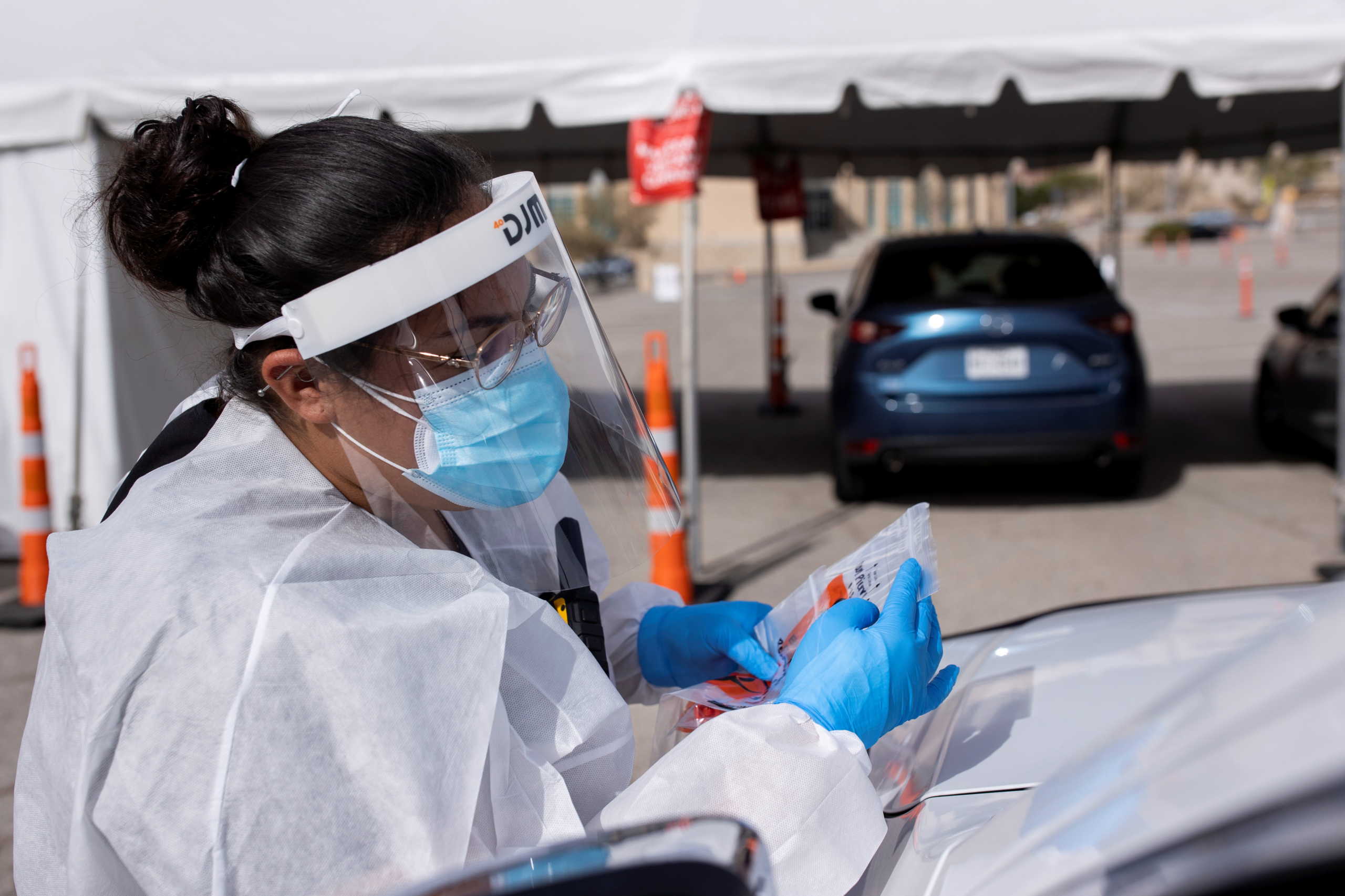 A medical personnel registers people before administering free Covid-19 tests at a state run drive-through testing site in the parking lot of the University of Texas El Paso campus amid the coronavirus disease (COVID-19) outbreak, in El Paso, Texas, U.S. November 23, 2020. REUTERS