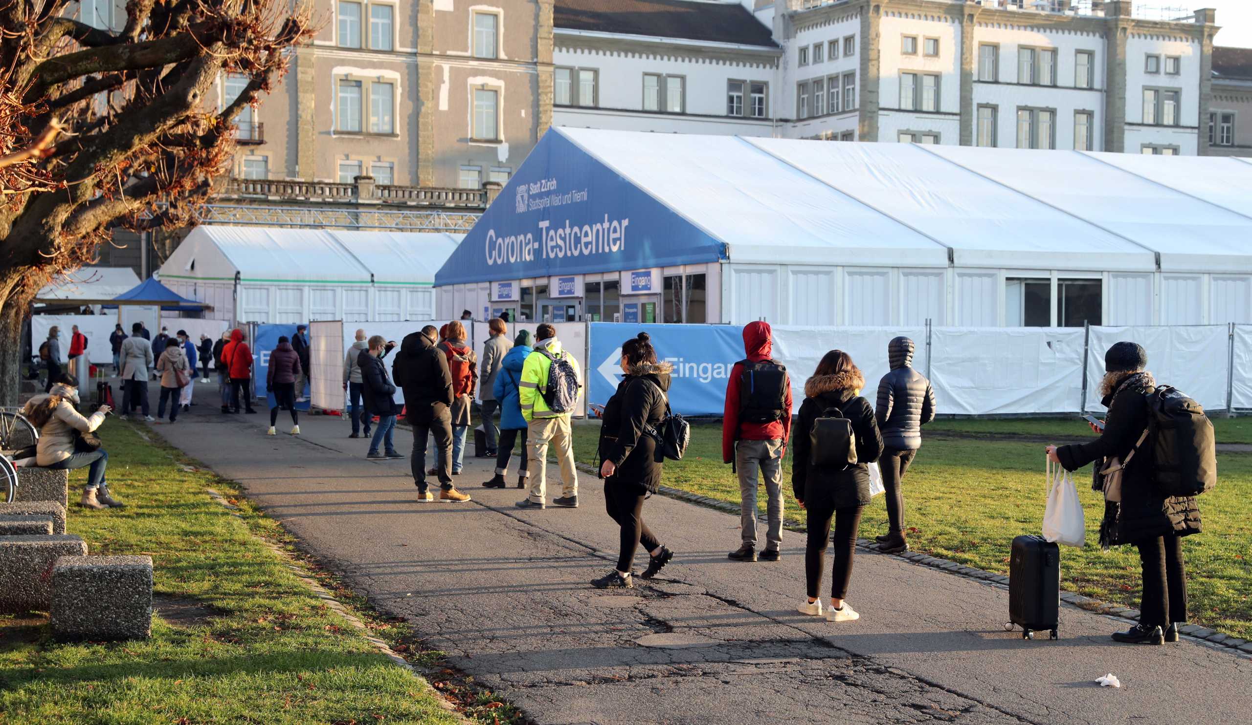 People queue in front of a COVID-19 testing site of the Stadtspital Waid and Triemli hospital, as the spread of the coronavirus disease (COVID-19) continues, in Zurich, Switzerland December 18, 2020. REUTERS