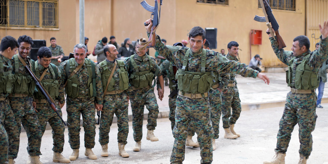 FILE PHOTO: Fighters from a new border security force under the command of Syrian Democratic Forces (SDF) dance during a graduation ceremony in Hasaka, northeastern Syria, January 20, 2018. REUTERS