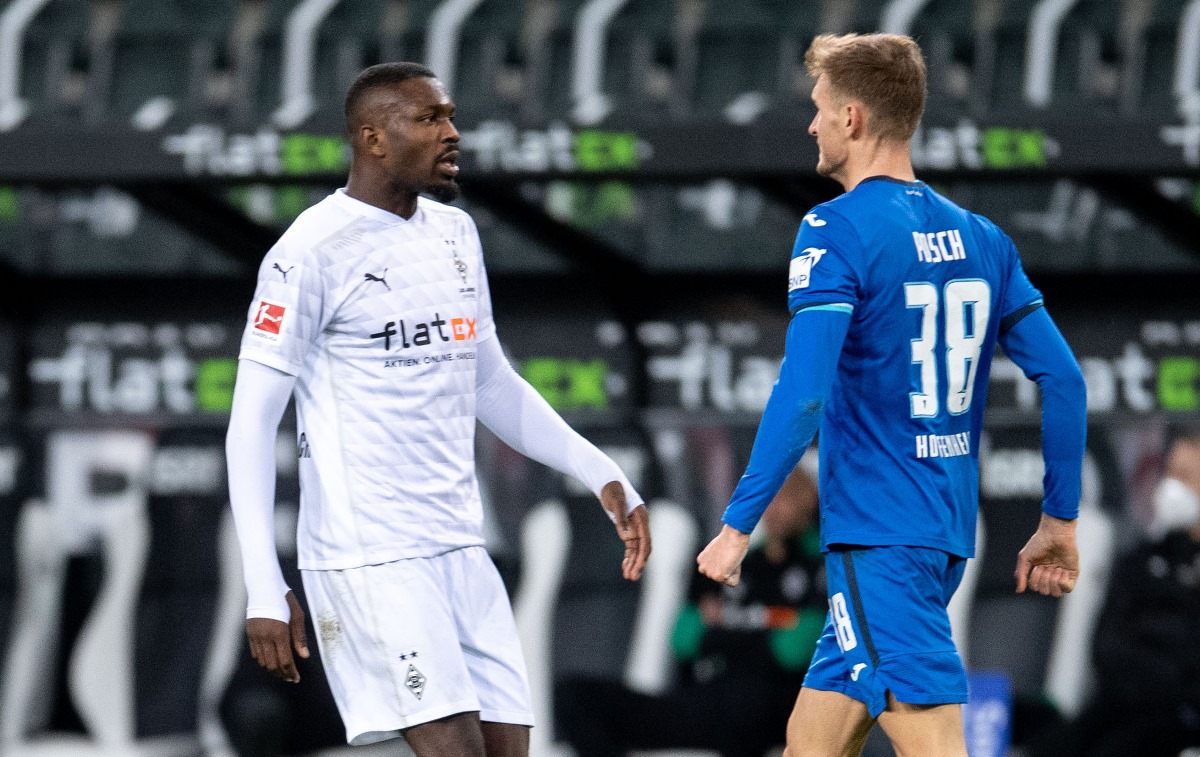 Soccer Football - Bundesliga - Borussia Moenchengladbach v TSG 1899 Hoffenheim - Borussia-Park, Moenchengladbach, Germany - December 19, 2020 Borussia Moenchengladbach's Marcus Thuram and TSG 1899 Hoffenheim's Stefan Posch clash Pool via REUTERS