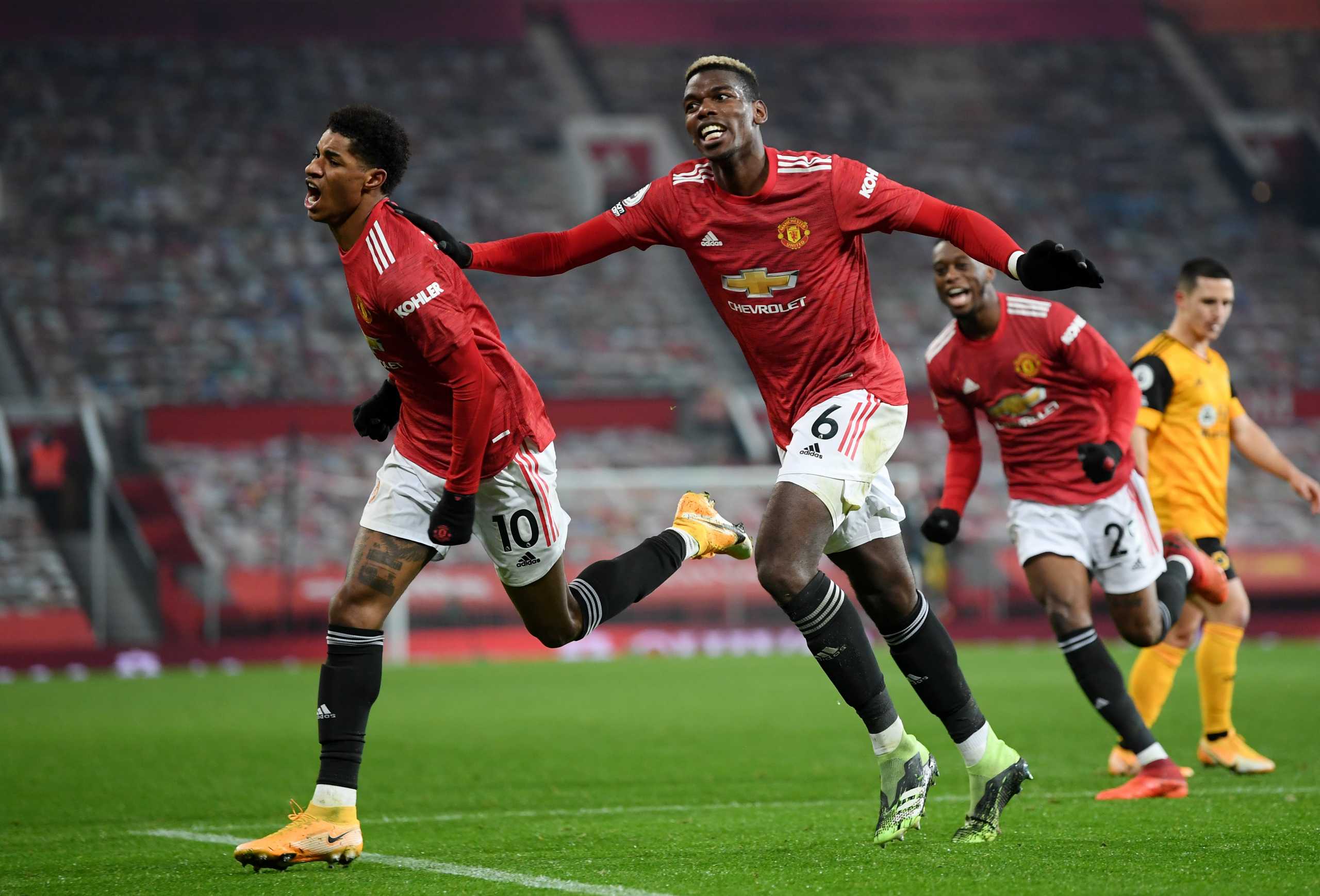 Soccer Football - Premier League - Manchester United v Wolverhampton Wanderers - Old Trafford, Manchester, Britain - December 29, 2020 Manchester United's Marcus Rashford celebrates scoring their first goal with Paul Pogba Pool via REUTERS