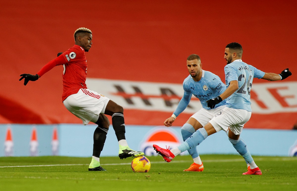 Soccer Football - Premier League - Manchester United v Manchester City - Old Trafford, Manchester, Britain - December 12, 2020 Manchester United's Paul Pogba in action with Manchester City's Riyad Mahrez and Kyle Walker Pool via REUTERS