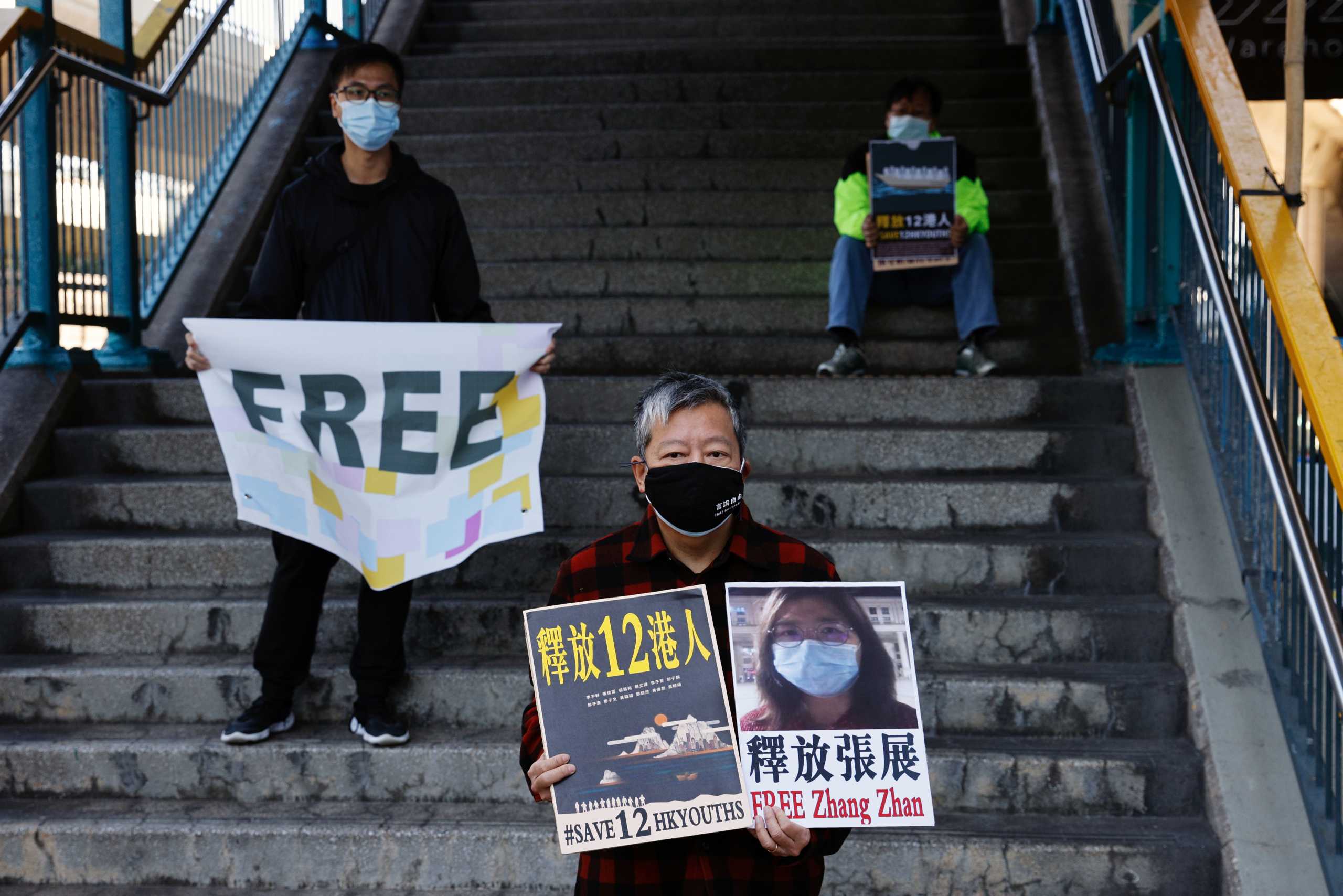 Pro-democracy supporters protest to urge for the release of 12 Hong Kong activists arrested as they reportedly sailed to Taiwan for political asylum and citizen journalist Zhang Zhan outside China's Liaison Office, in Hong Kong, China December 28, 2020. REUTERS
