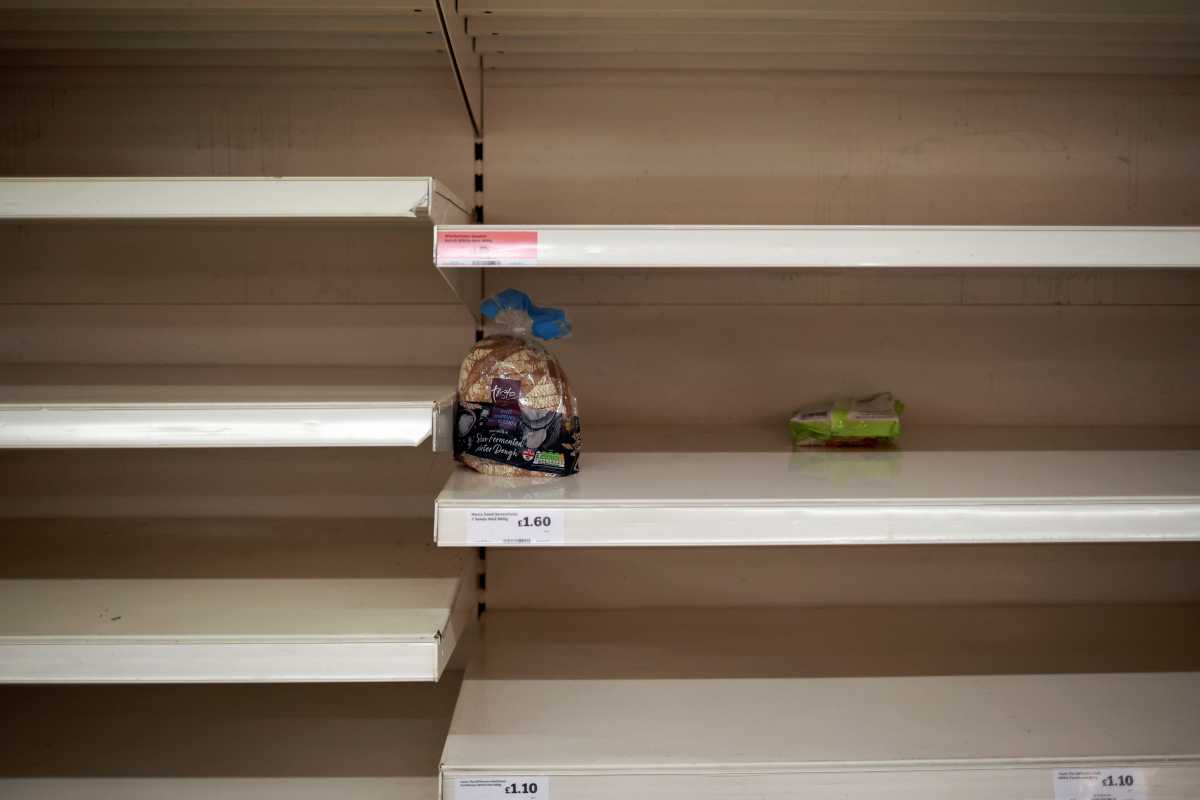 Bread is seen on an almost empty shelf as people shop at a Sainsbury's store, amid the coronavirus disease (COVID-19) outbreak, in London, Britain December 21, 2020. REUTERS