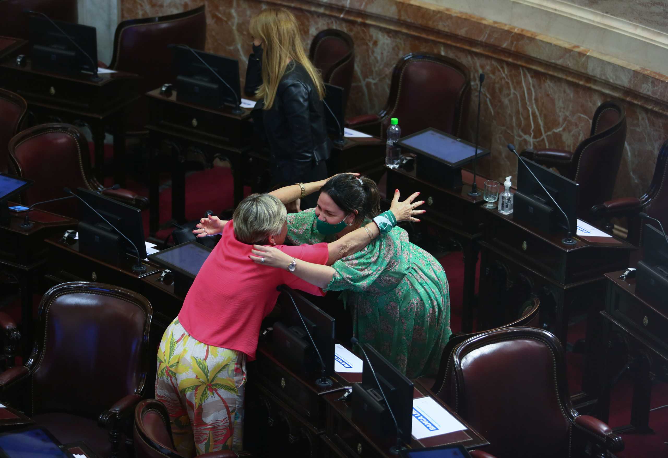 Two women hug as the senate debates an abortion bill, in Buenos Aires, Argentina, December 30, 2020. REUTERS