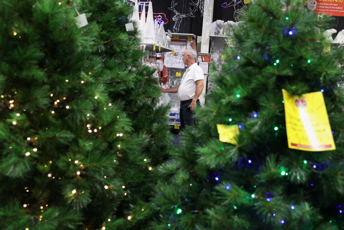 A customer shops inside a Christmas store as coronavirus disease (COVID-19) regulations are further eased for the state of New South Wales in Sydney, Australia, November 26, 2020.  REUTERS