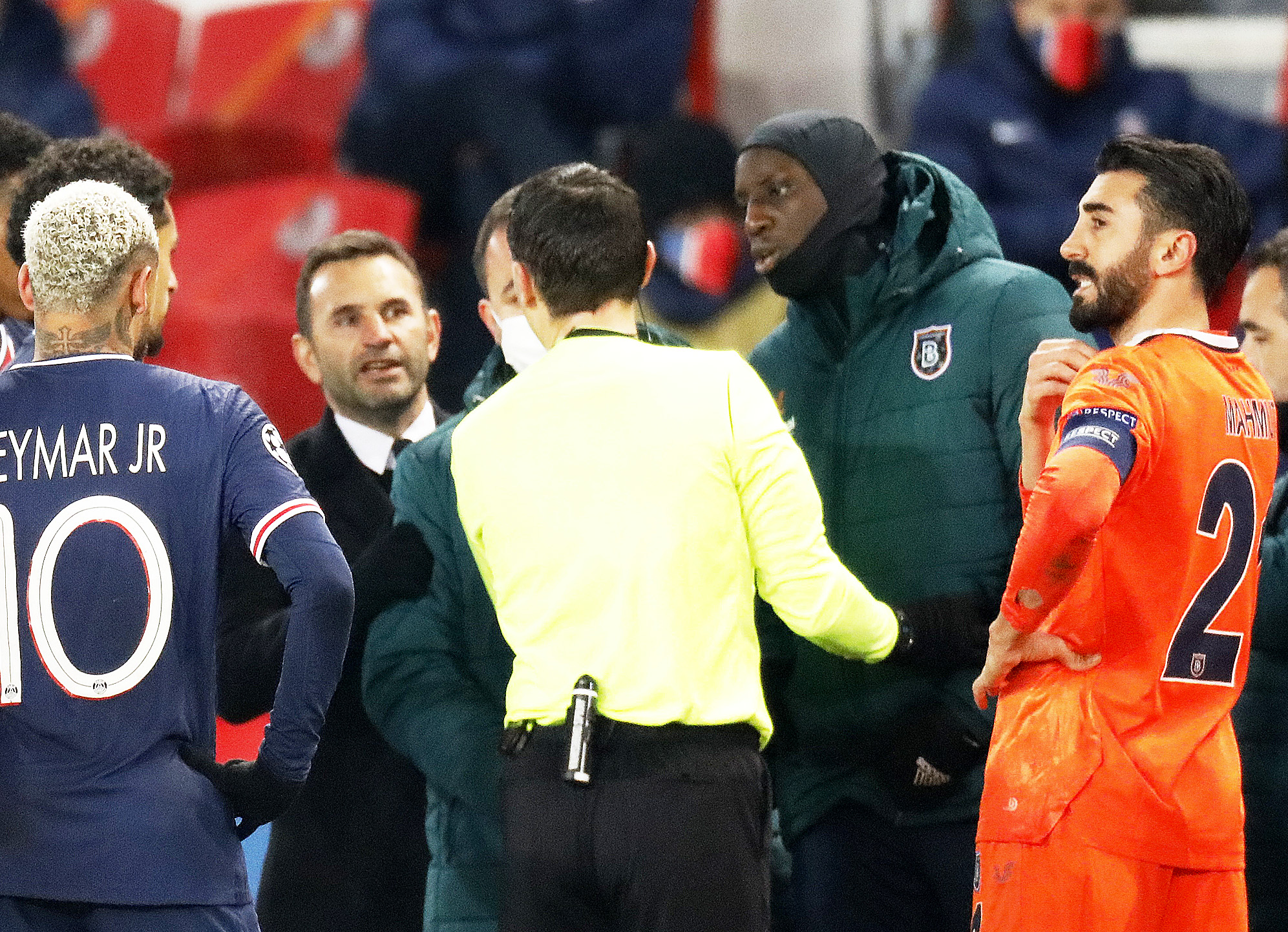 Soccer Football - Champions League - Group H - Paris St Germain v Istanbul Basaksehir F.K. - Parc des Princes, Paris, France - December 8, 2020 Referee Ovidiu Hategan with Istanbul Basaksehir's Demba Ba as the match is interrupted REUTERS