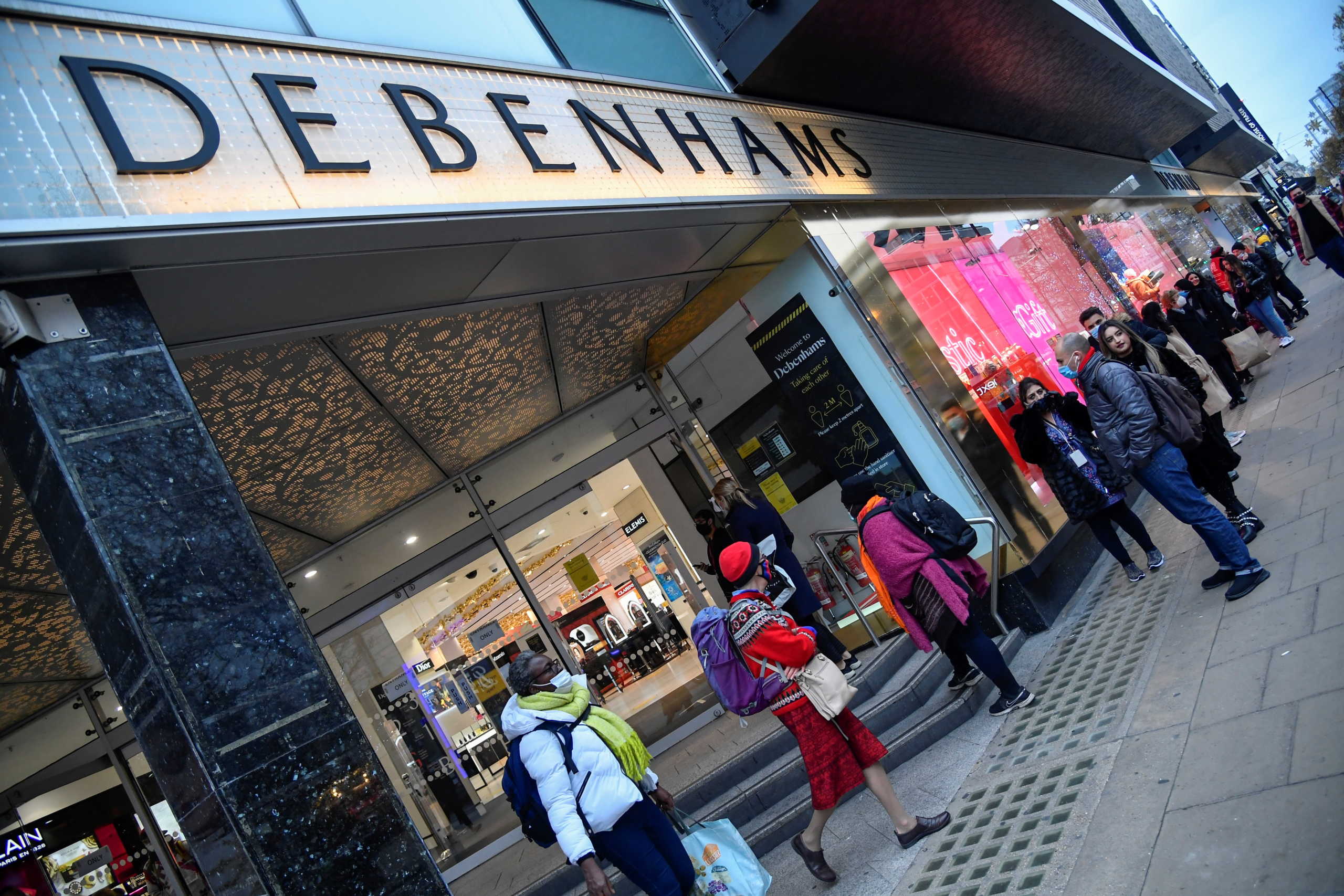 Shoppers queue to enter a Debenhams store, as a second lockdown in England ends, amid the outbreak of the coronavirus disease (COVID-19), in Oxford Street, London, Britain, December 2, 2020. REUTERS