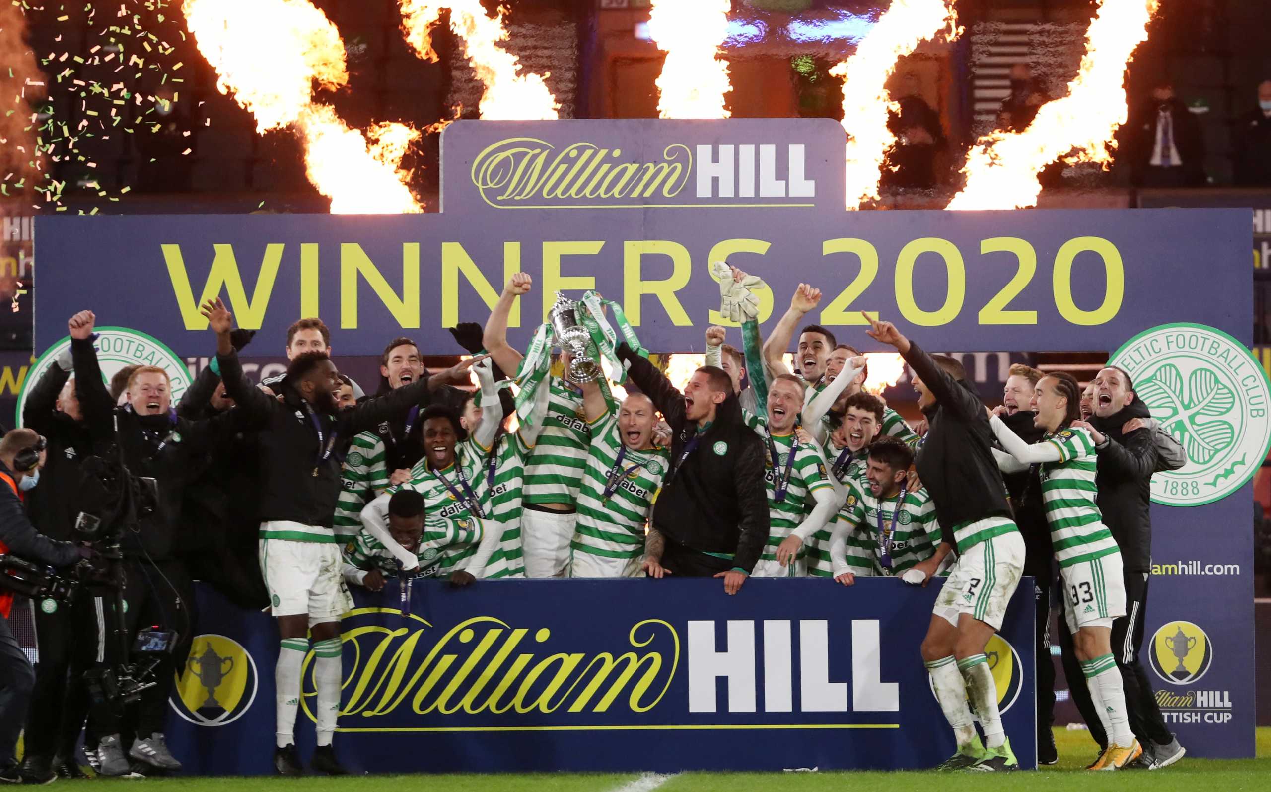Soccer Football - Scottish Cup - Final - Celtic v Heart of Midlothian - Celtic Park, Glasgow, Scotland, Britain - December 20, 2020 Celtic's Scott Brown celebrates with the trophy and teammates after winning the Scottish Cup final REUTERS