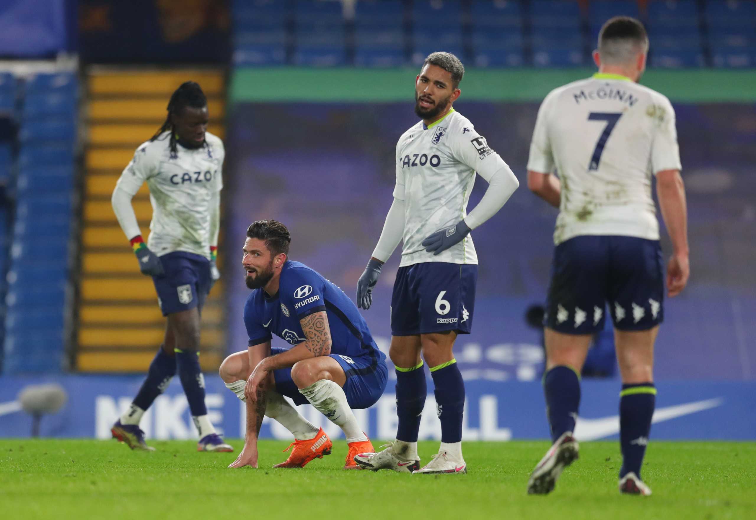 Soccer Football - Premier League - Chelsea v Aston Villa - Stamford Bridge, London, Britain - December 28, 2020 Chelsea's Olivier Giroud and Aston Villa's Douglas Luiz react after first half Pool via REUTERS