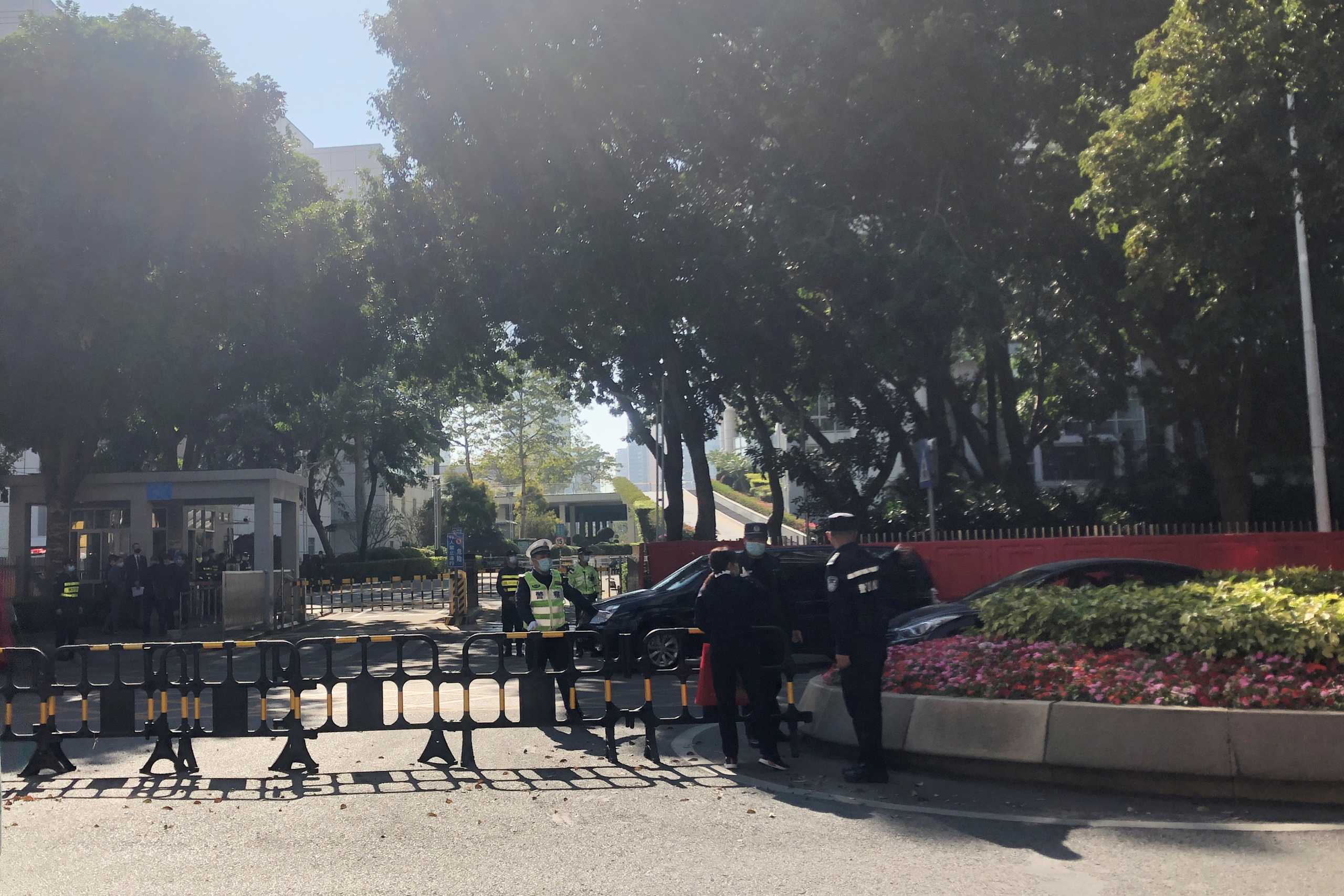 Police officers are seen outside Yantian District People's Court, where ten of the twelve Hong Kongers who were detained in Chinese waters while fleeing the city are expected to stand trial, in Shenzhen, Guangdong province, China December 28, 2020. REUTERS