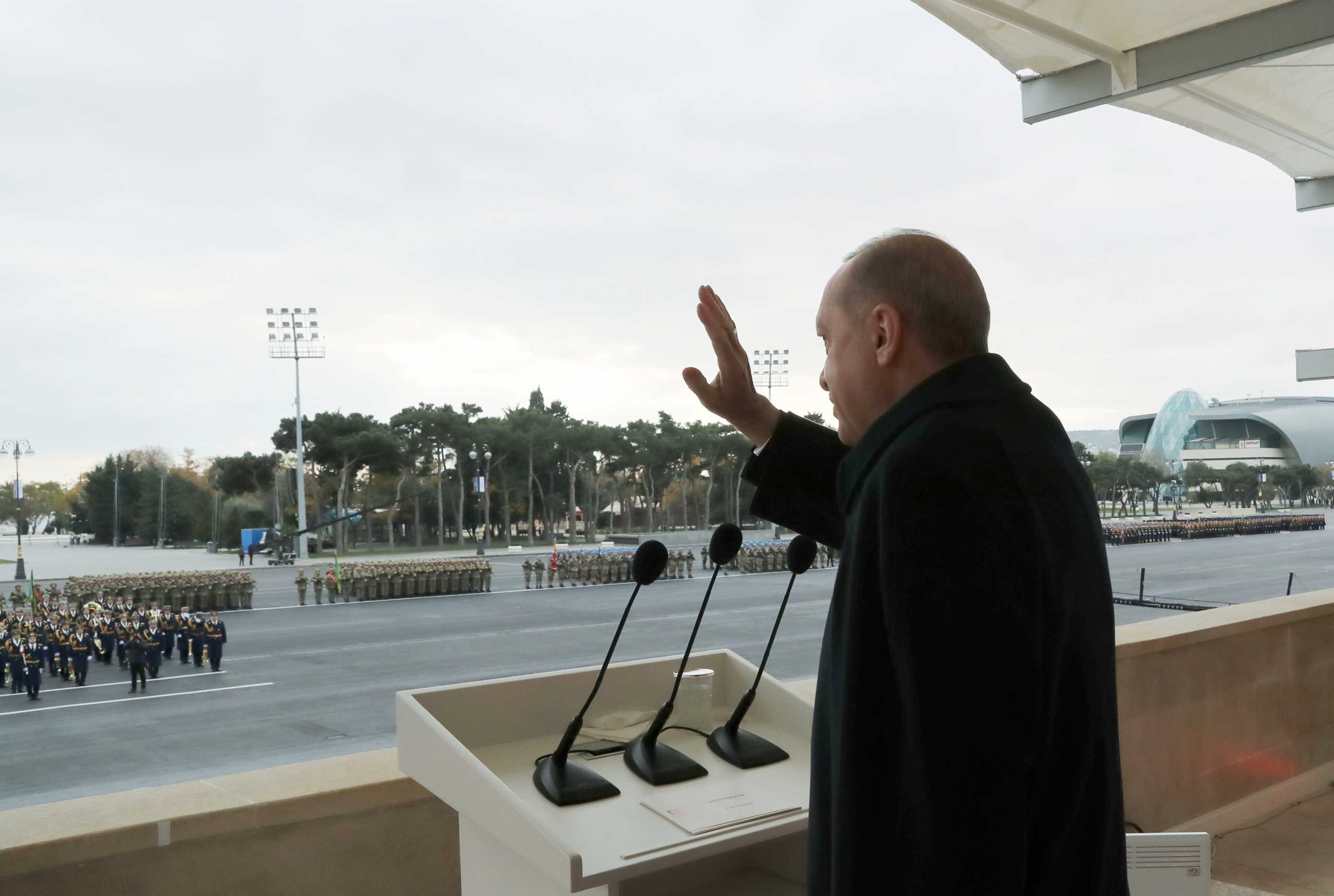 Turkish President Tayyip Erdogan greets troops during a military parade to mark the victory on Nagorno-Karabakh conflict, in Baku, Azerbaijan December 10, 2020. Murat Cetinmuhurdar