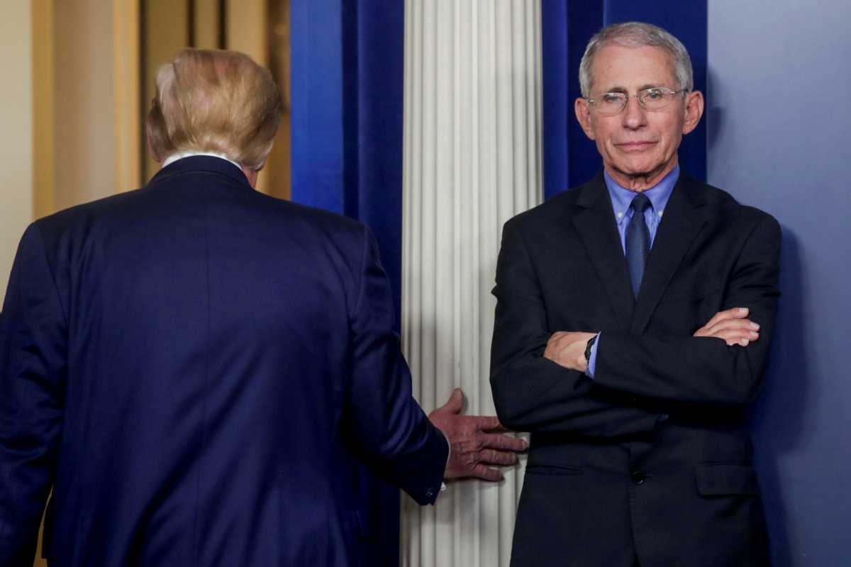 U.S. President Donald Trump departs after addressing the coronavirus task force daily briefing as Dr. Anthony Fauci, director of the National Institute of Allergy and Infectious Diseases, stands by at the White House in Washington, U.S., March 26, 2020. REUTERS