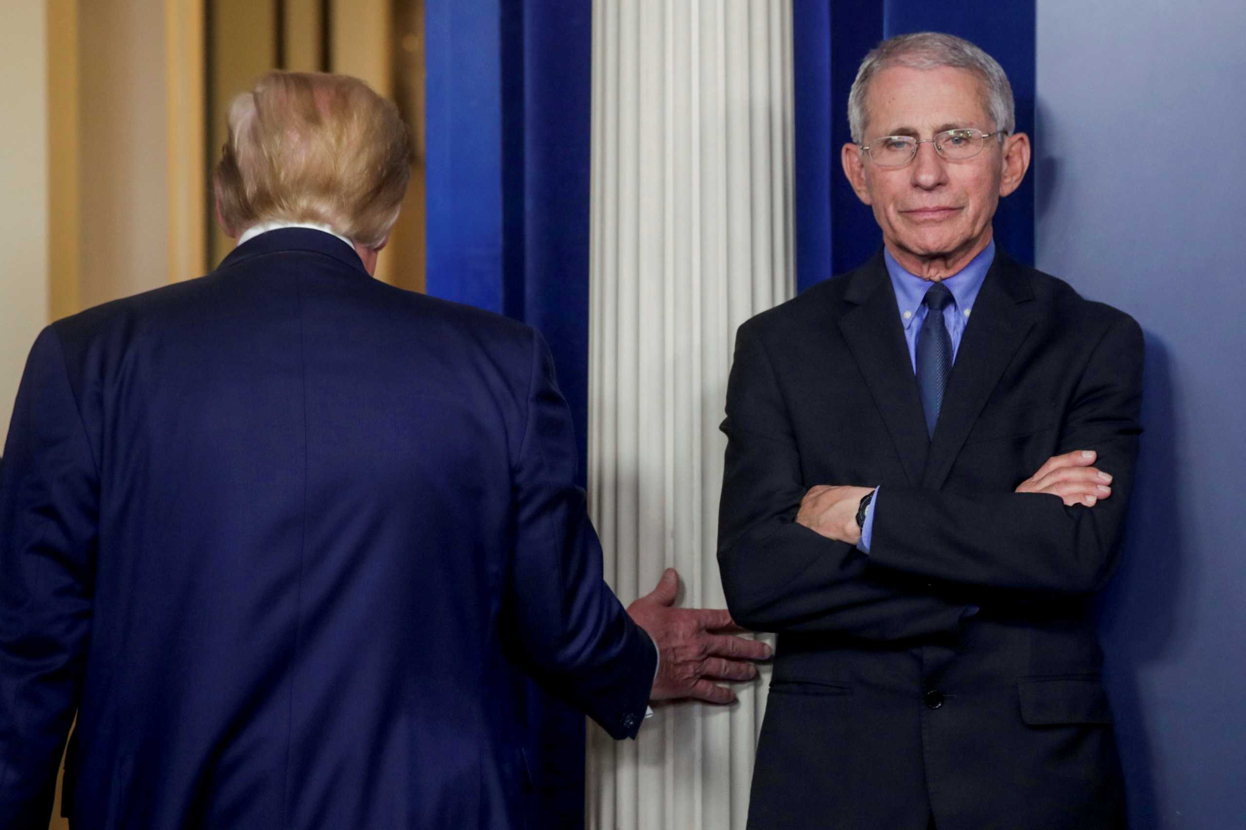 U.S. President Donald Trump departs after addressing the coronavirus task force daily briefing as Dr. Anthony Fauci, director of the National Institute of Allergy and Infectious Diseases, stands by at the White House in Washington, U.S., March 26, 2020. REUTERS