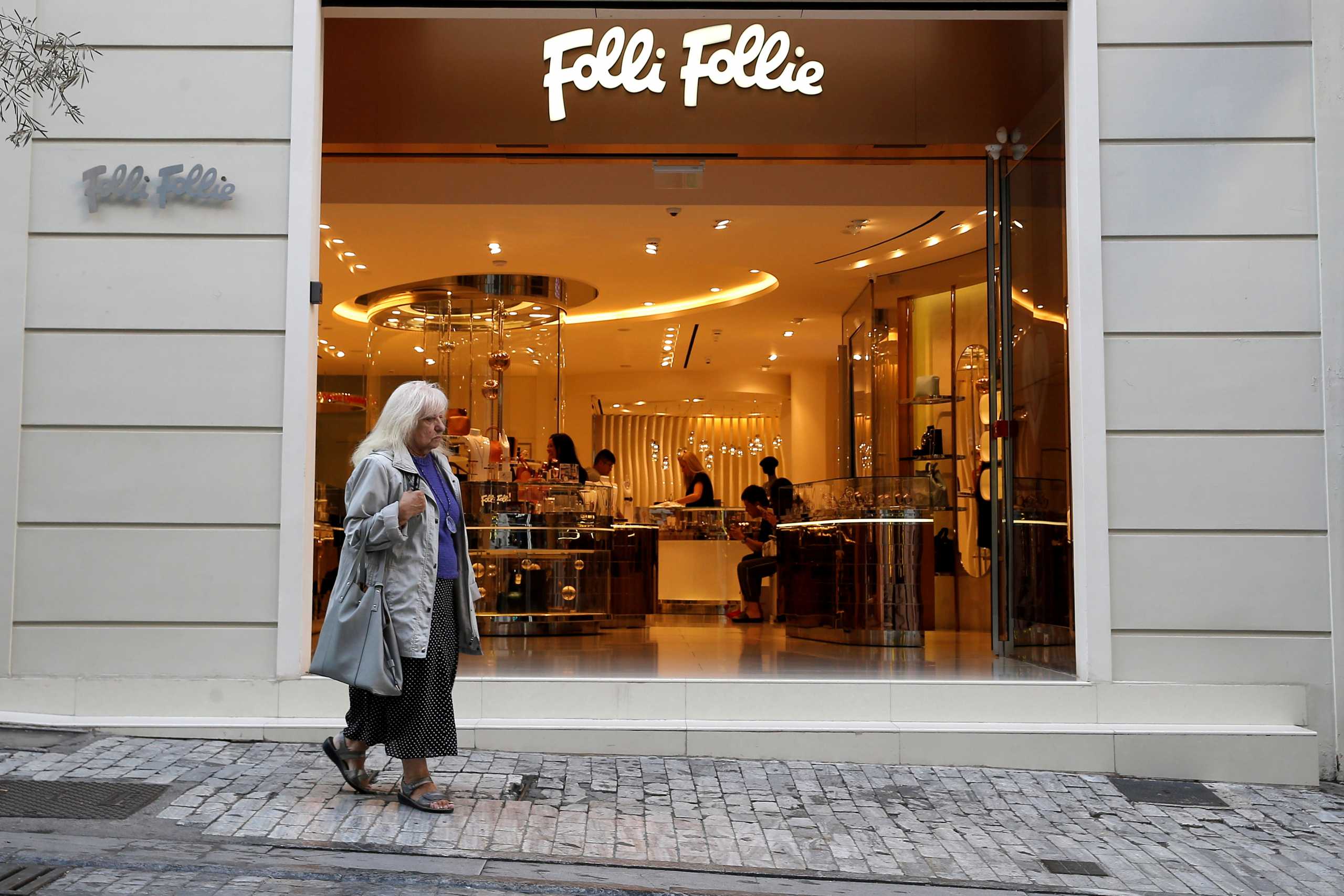 FILE PHOTO: A woman walks past a Folli Follie store in central Athens, Greece, October 10 2018.REUTERS