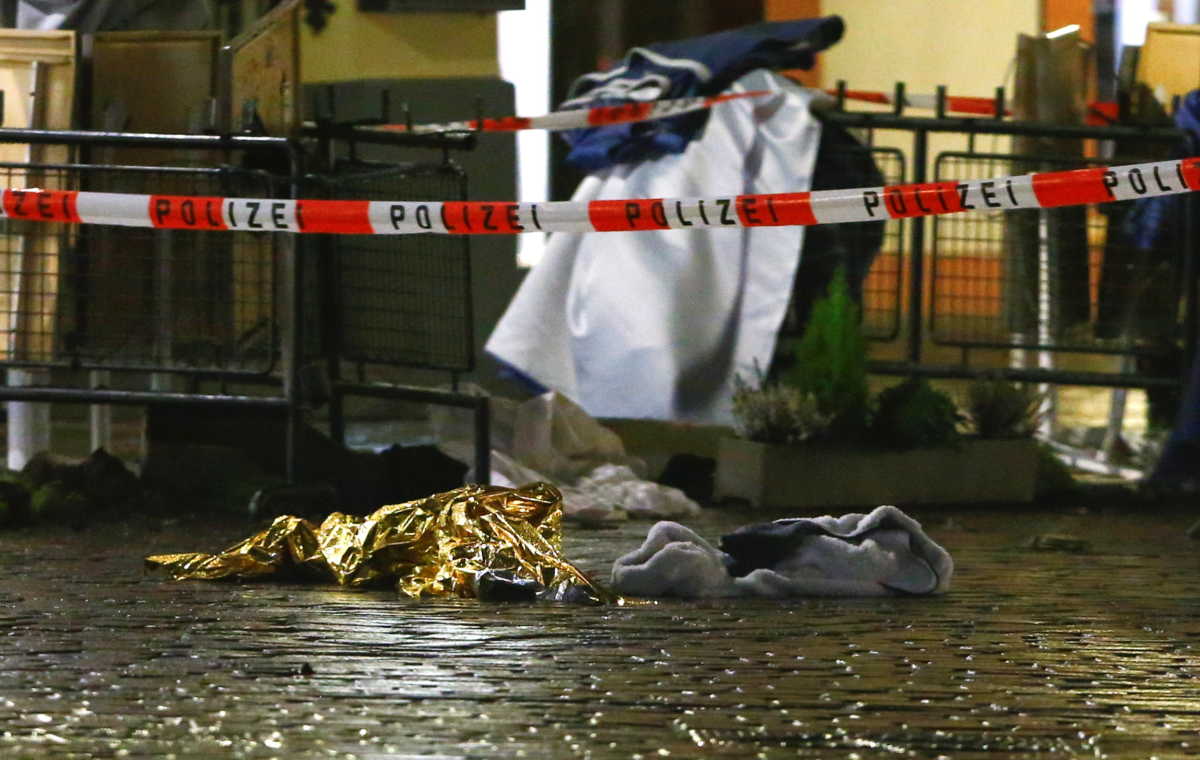 A baby onesie lies on the ground next to a thermal blanket at the site where a car crashed into pedestrians in Trier, Germany, December 1, 2020. REUTERS