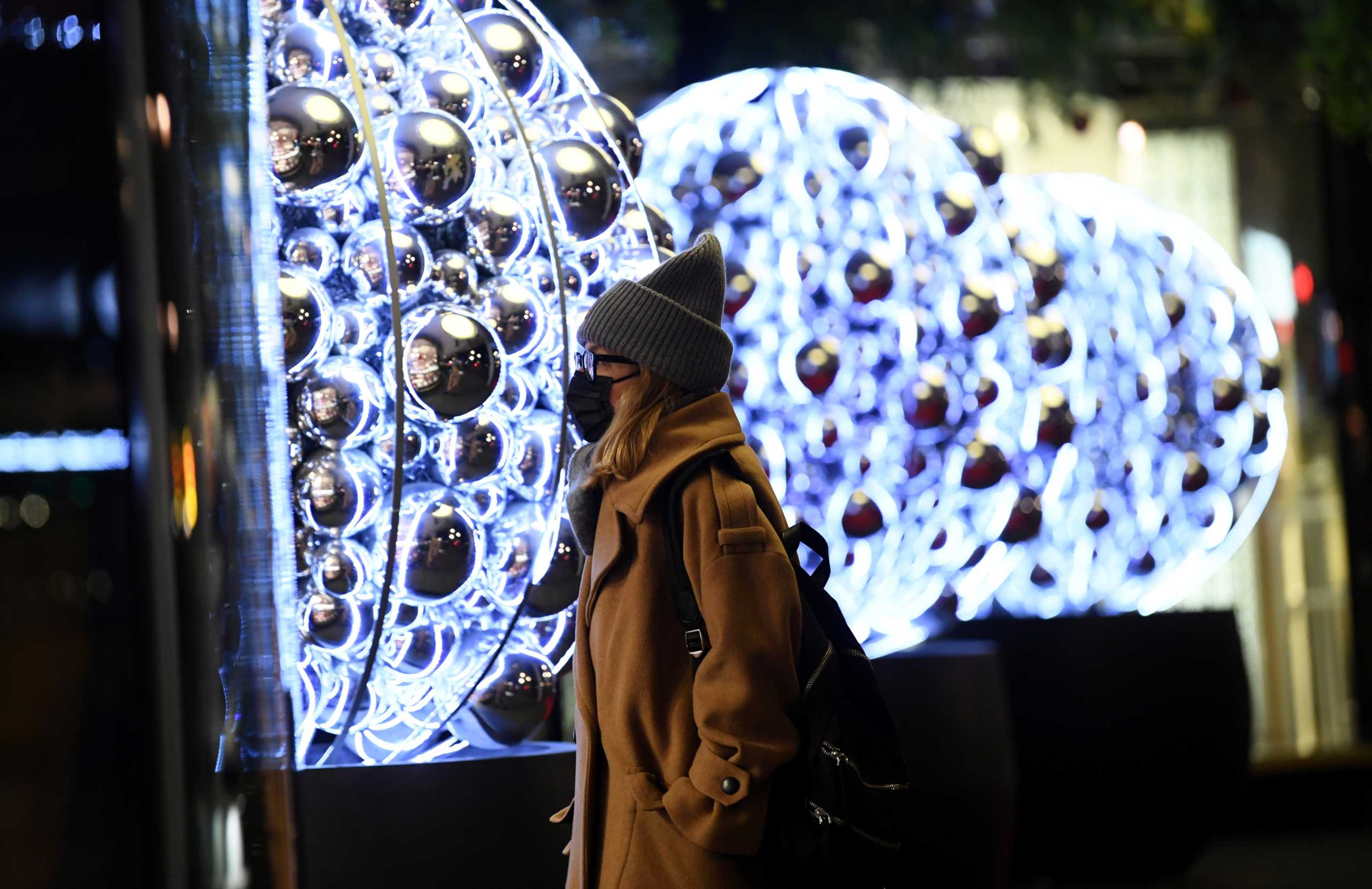 A woman is seen in front of the shopping mall Bikini, before Germany goes back to a nationwide hard lockdown due to the coronavirus disease (COVID-19) outbreak, in Berlin, Germany, December 15, 2020.  REUTERS