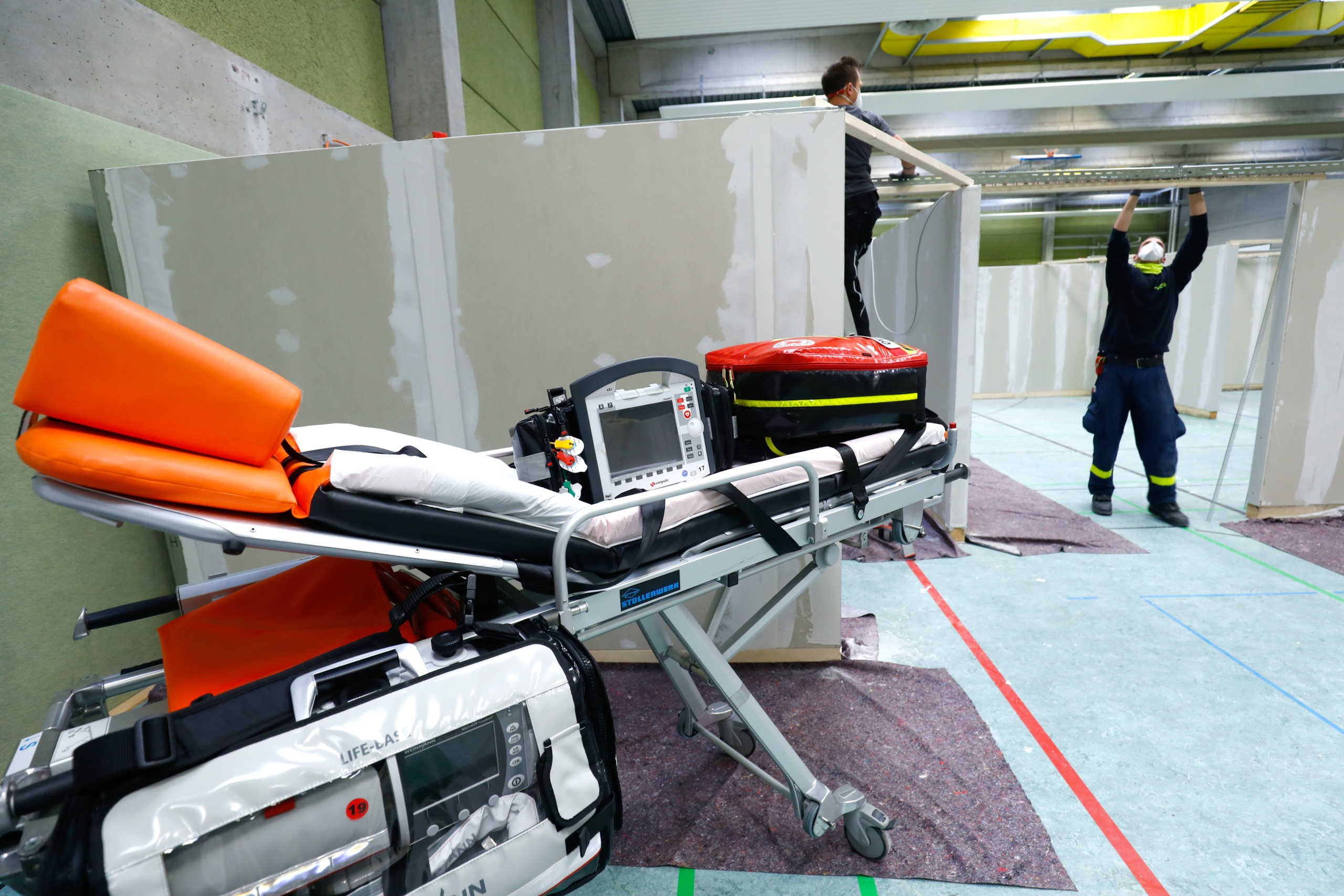 Members of the Federal Agency for Technical Relief (THW) work at a vaccination centre that's under construction in Eschwege near Kassel, Germany, December 1, 2020.   REUTERS