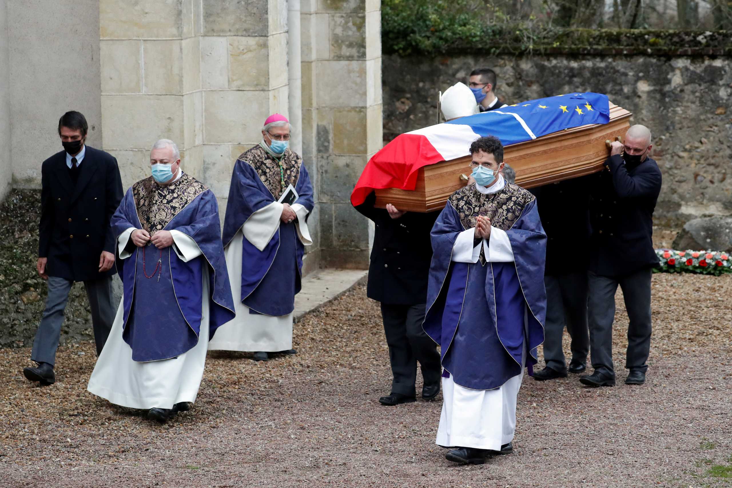 Pallbearers carry the coffin, draped with a French flag and an European Union flag, of late former French President Valery Giscard d'Estaing to the family's private area near the cemetery during his funeral ceremony in Authon, France, December 5, 2020. REUTERS