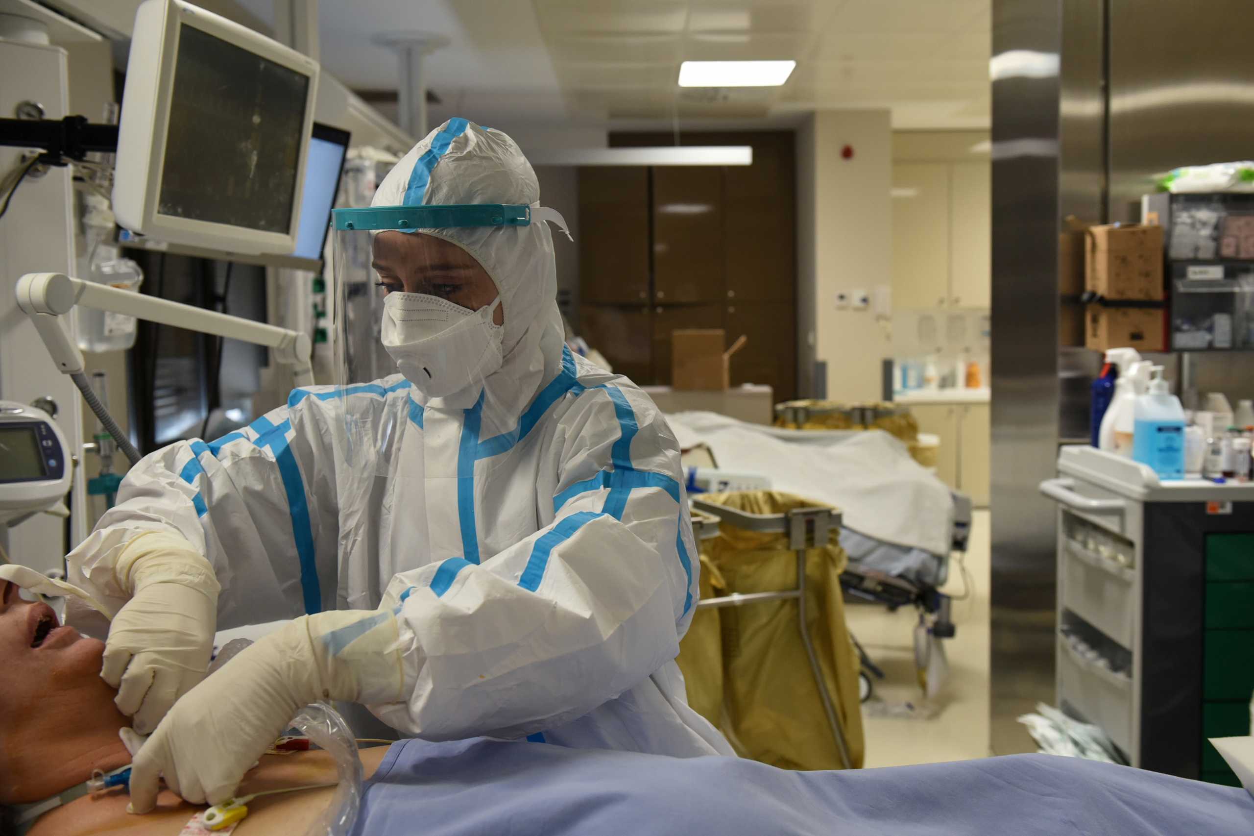 A medical worker wearing personal protective equipment (PPE) takes care of a patient at the intensive care unit (ICU) of the George Papanikolaou General Hospital, during the coronavirus disease (COVID-19) pandemic in Thessaloniki, Greece, November 11, 2020. Picture taken November 11, 2020. REUTERS