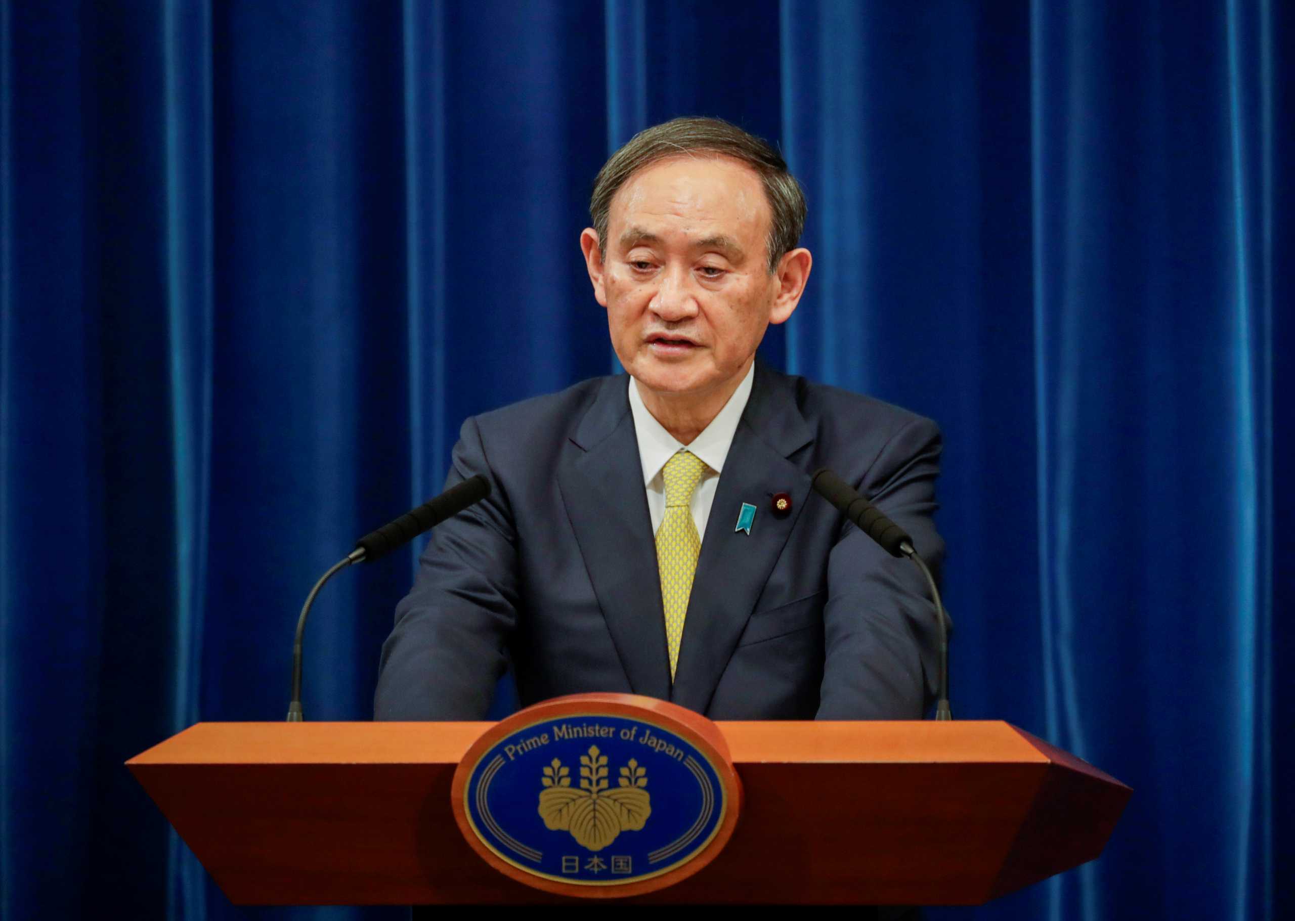 FILE PHOTO: Japanese Prime Minister Yoshihide Suga speaks during a news conference in Tokyo, Japan December 4, 2020. Hiro Komae