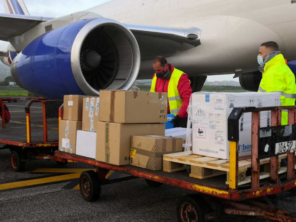 Workers unload a plane carrying new batches of the Pfizer COVID-19 vaccine at the Tenerife North airport in Tenerife, Canary Islands, Spain, December 29, 2020. Moncloa Palace