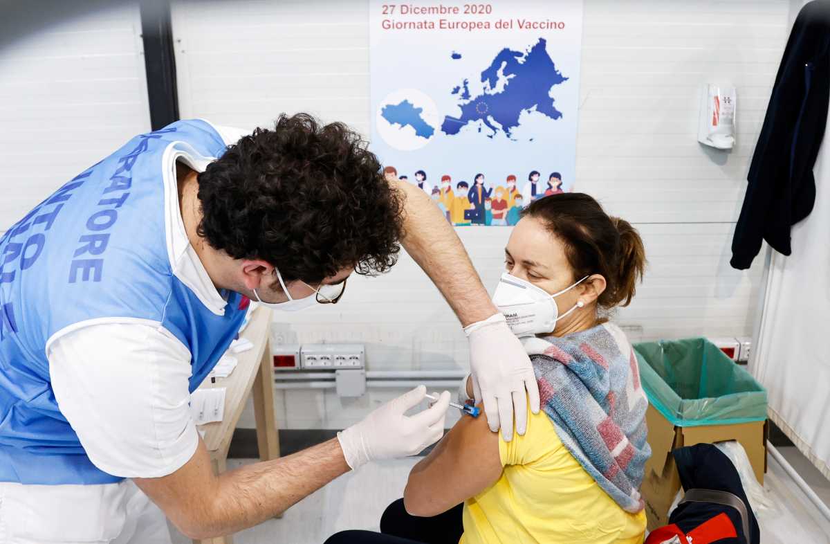 A woman receives the Pfizer-BioNTech COVID-19 vaccine against the coronavirus disease at the Cardarelli hospital in Naples, Italy, December 27, 2020. REUTERS