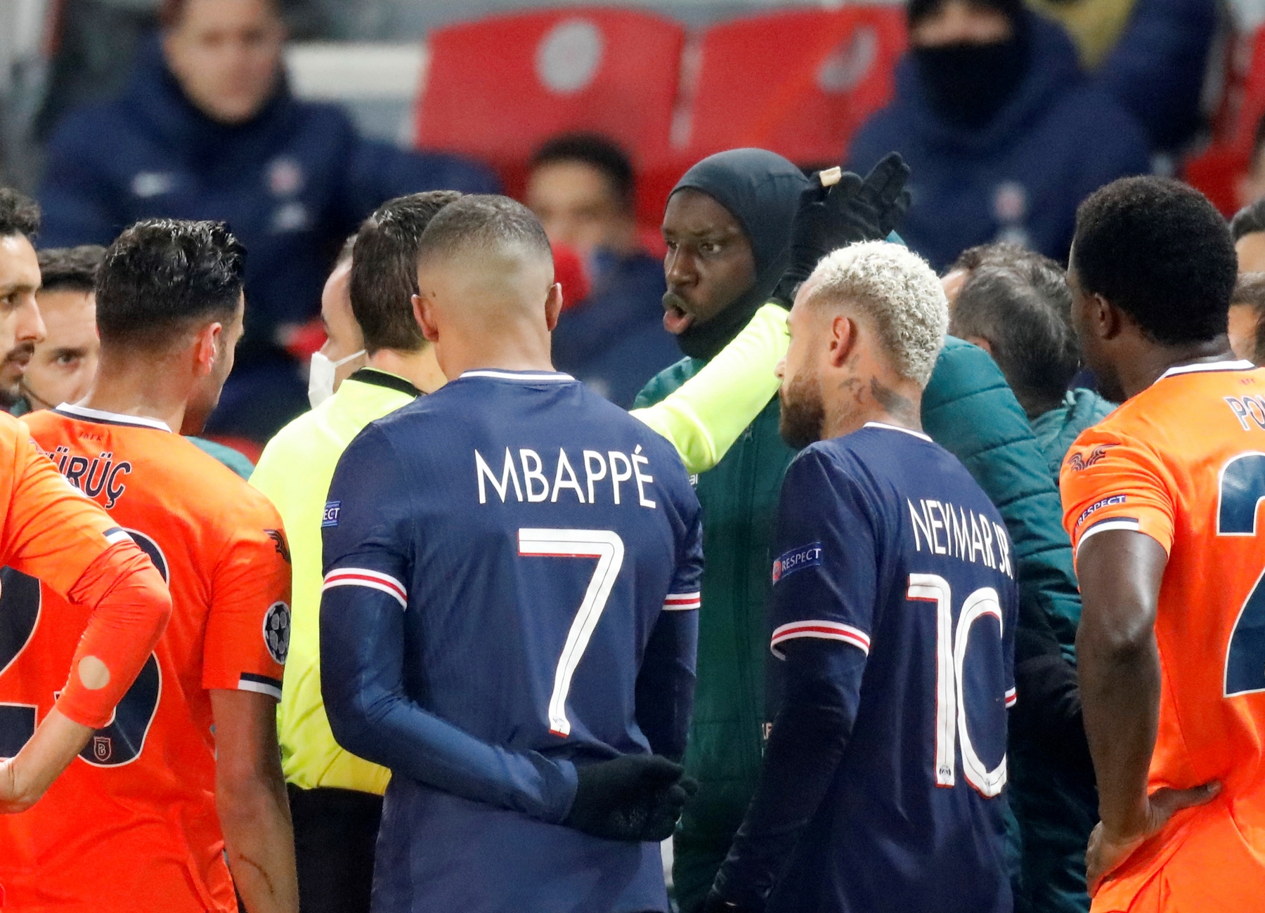Soccer Football - Champions League - Group H - Paris St Germain v Istanbul Basaksehir F.K. - Parc des Princes, Paris, France - December 8, 2020 Referee Ovidiu Hategan with Istanbul Basaksehir's Demba Ba as the match is interrupted REUTERS