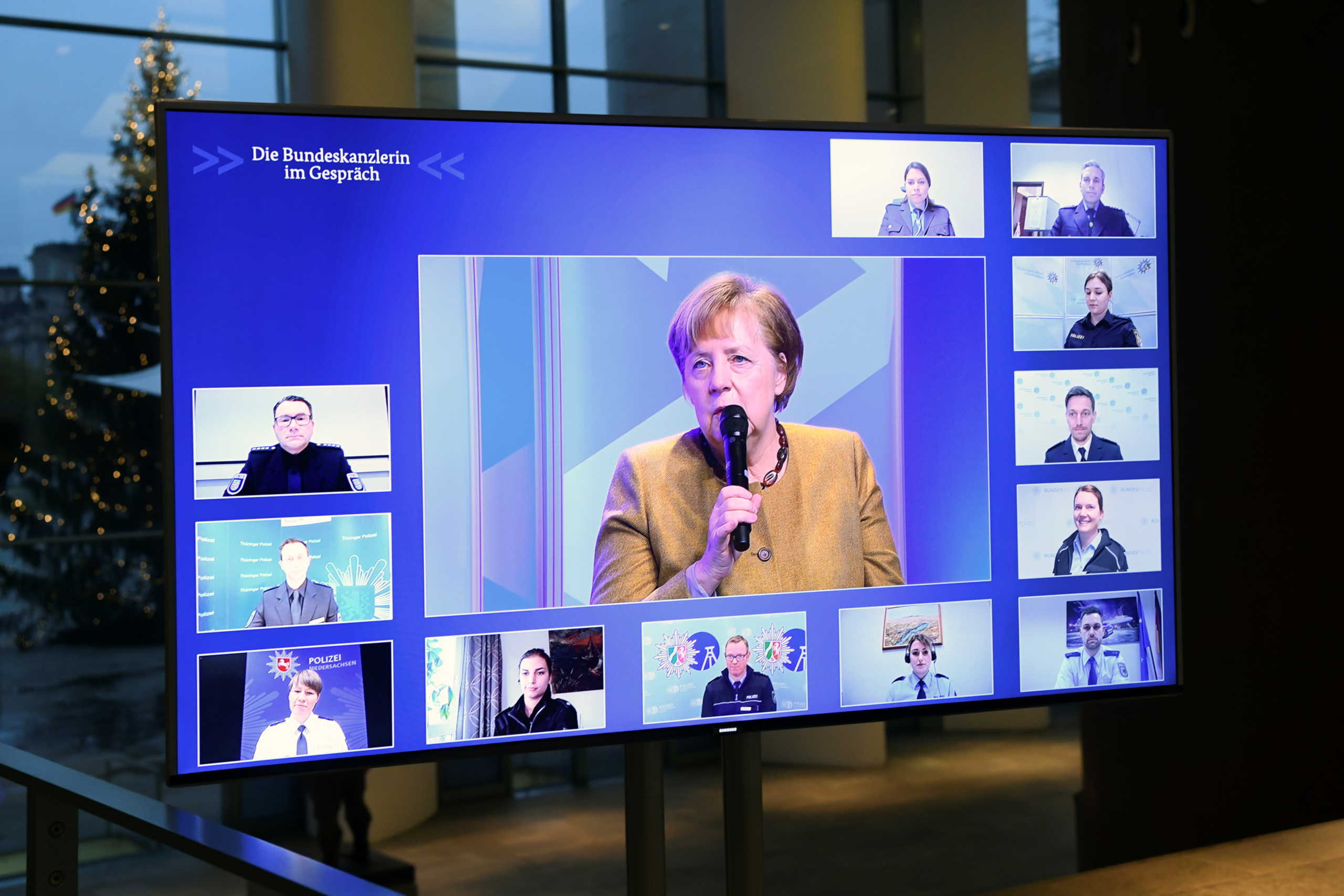 German Chancellor Angela Merkel is seen on a screen as she attends a virtual meeting with police officers, while the spread of the coronavirus disease (COVID-19) continues, at the Chancellery in Berlin, Germany, November 30, 2020. REUTERS