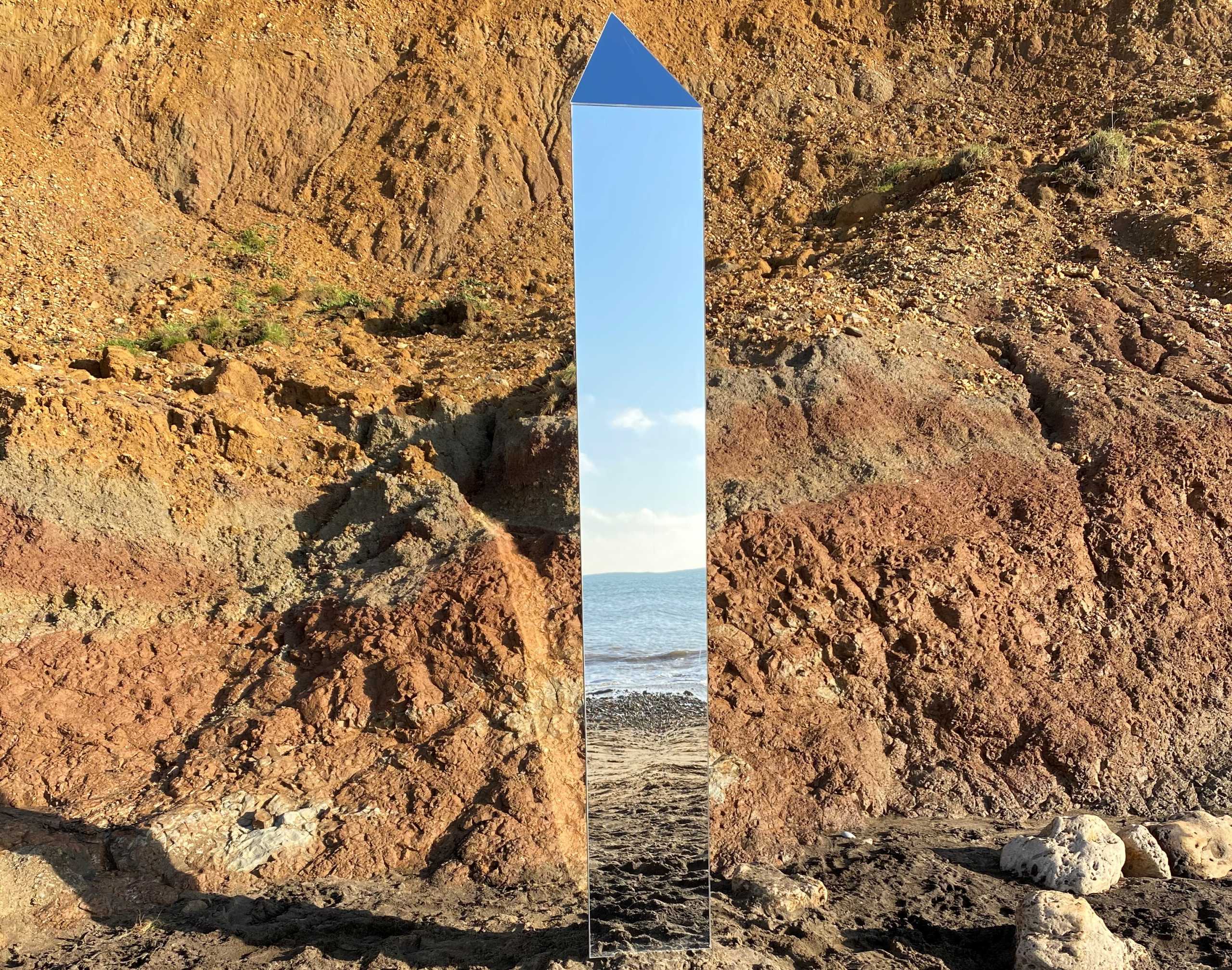 The shoreline is reflected in a metal object at Compton Beach, Isle of Wight, Britain December 6, 2020 in this image obtained from social media. Picture taken December 6, 2020. Twitter @AlexiaRFishwick via REUTERS ATTENTION EDITORS - THIS IMAGE HAS BEEN SUPPLIED BY A THIRD PARTY. NO RESALES. NO ARCHIVES. MANDATORY CREDIT