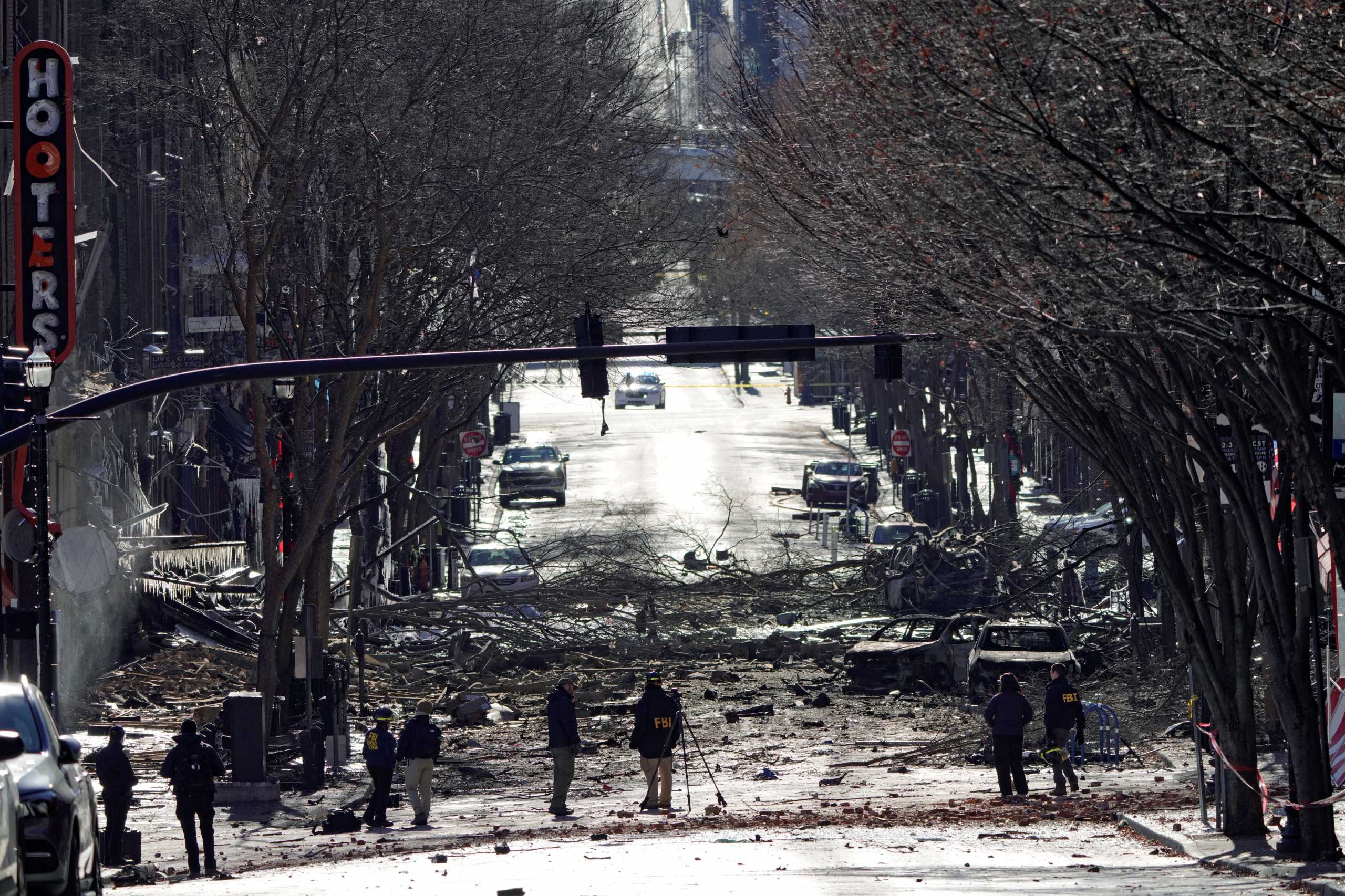 Investigators work near the site of an explosion on 2nd Avenue that occurred the day before in Nashville, Tennessee, U.S. December 26, 2020. REUTERS