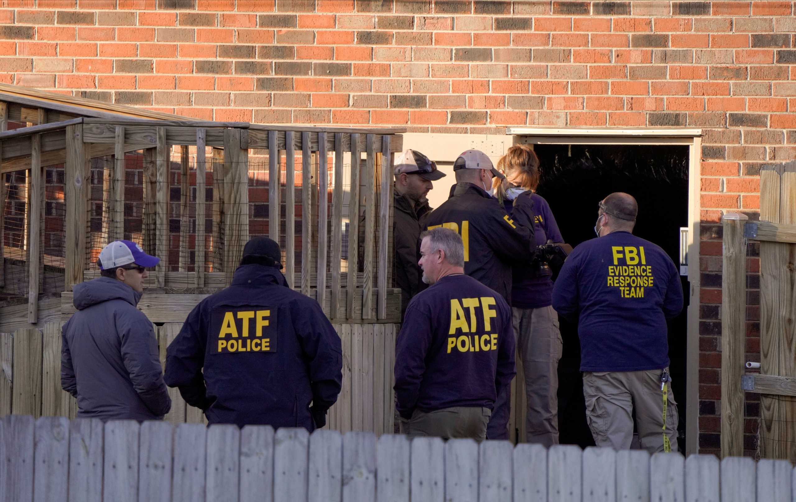 Law enforcement officers gather to investigate information arising the day after a downtown Nashville explosion, outside a duplex house in Antioch, Tennessee, U.S. December 26, 2020. REUTERS