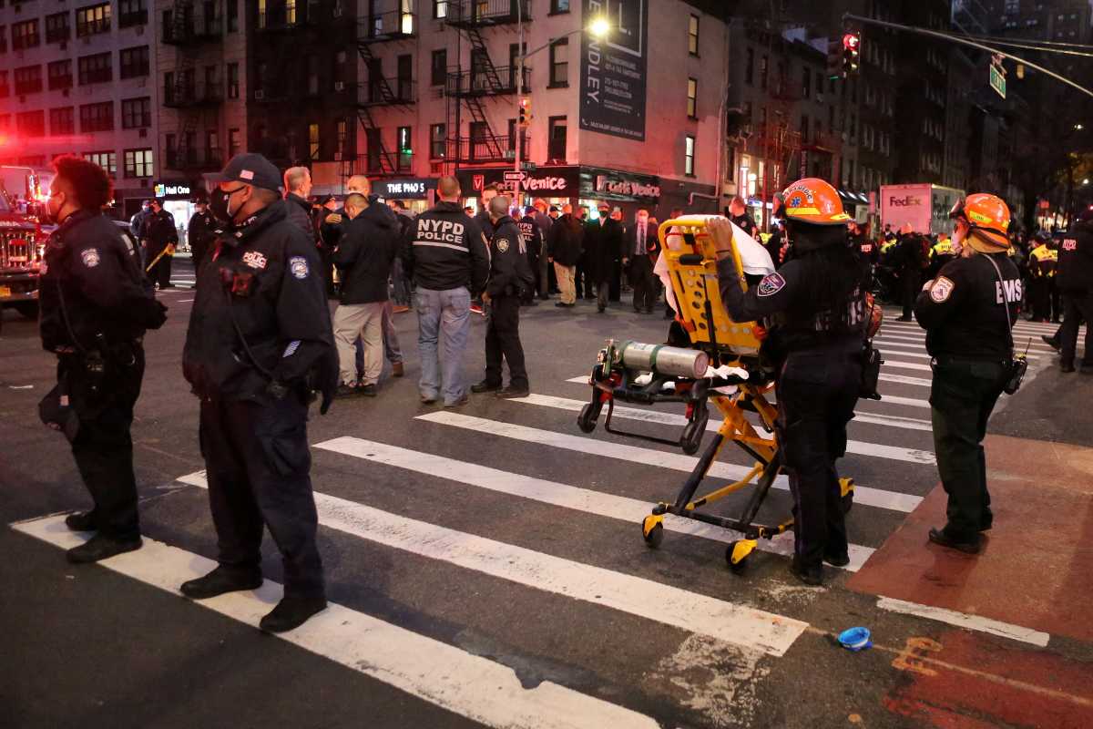 Police and EMS stand in the street at the location of a vehicle that struck multiple pedestrians at a protest on Third Avenue in the Manhattan borough of New York City, New York, U.S., December 11, 2020. REUTERS