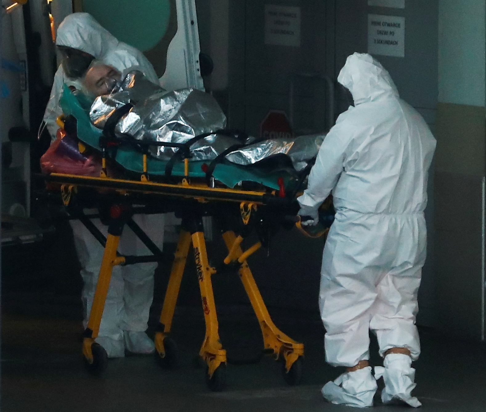 Paramedics transport a COVID-19 patient at a hospital in Warsaw, Poland December 3, 2020. REUTERS