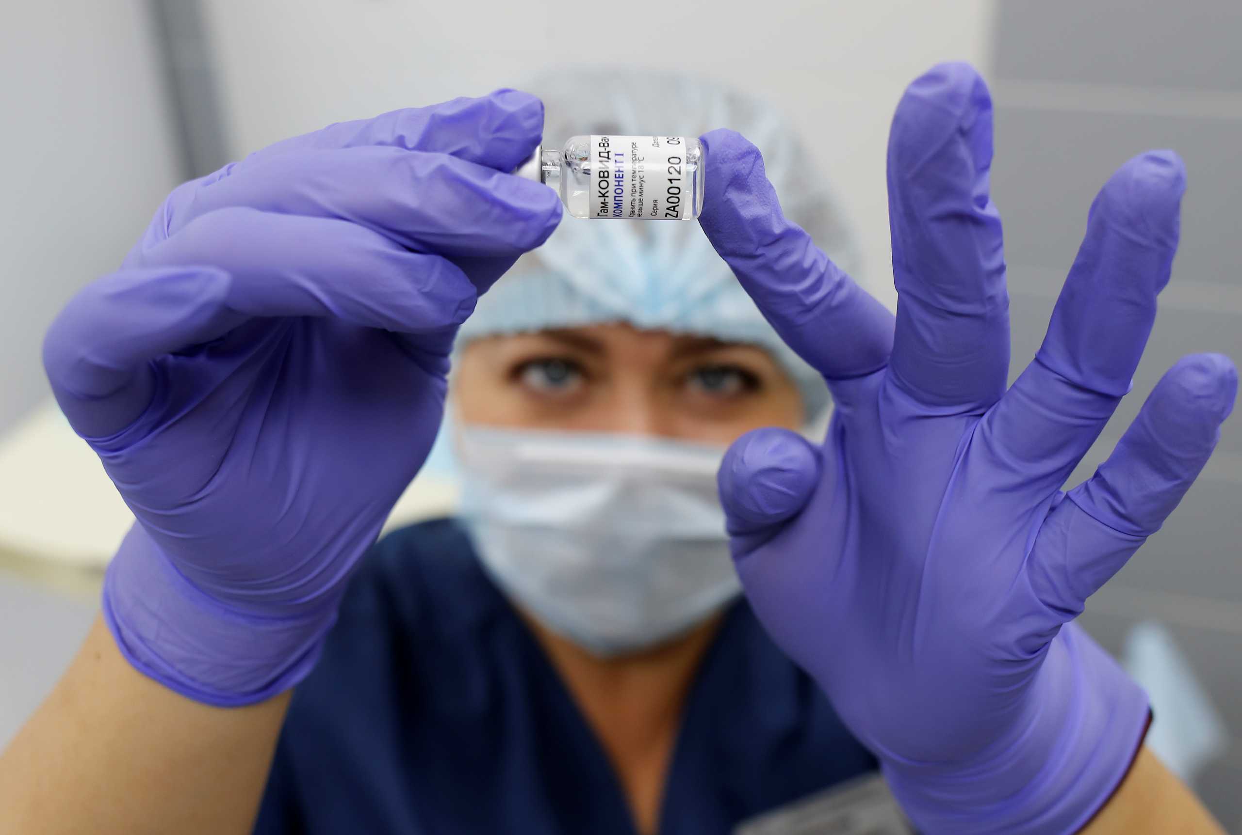A medical worker holds a vial with Sputnik V (Gam-COVID-Vac) vaccine during the vaccination against the coronavirus disease (COVID-19) at a clinic in the town of Domodedovo near Moscow, Russia December 3, 2020. REUTERS
