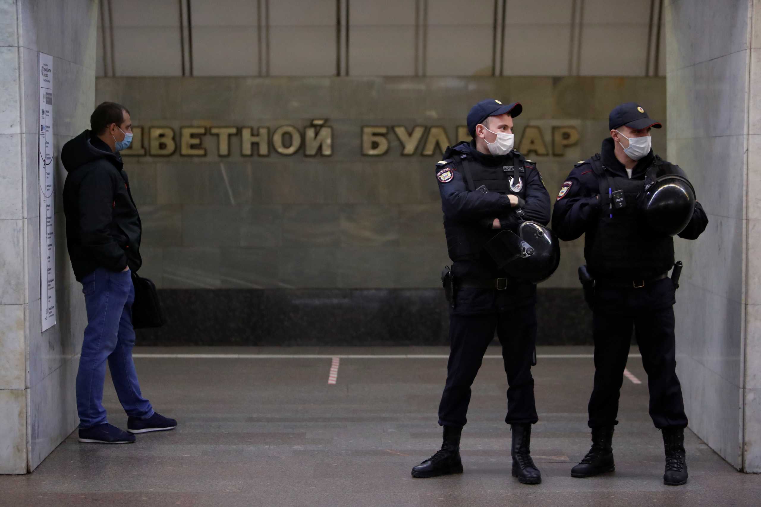 Police officers stand guard at Tsvetnoi Bulvar (Tsvetnoy Boulevard) metro station, as nationalists and activists of far-right political groups hold a rally near the station, on the National Unity Day in Moscow, Russia November 4, 2020. REUTERS