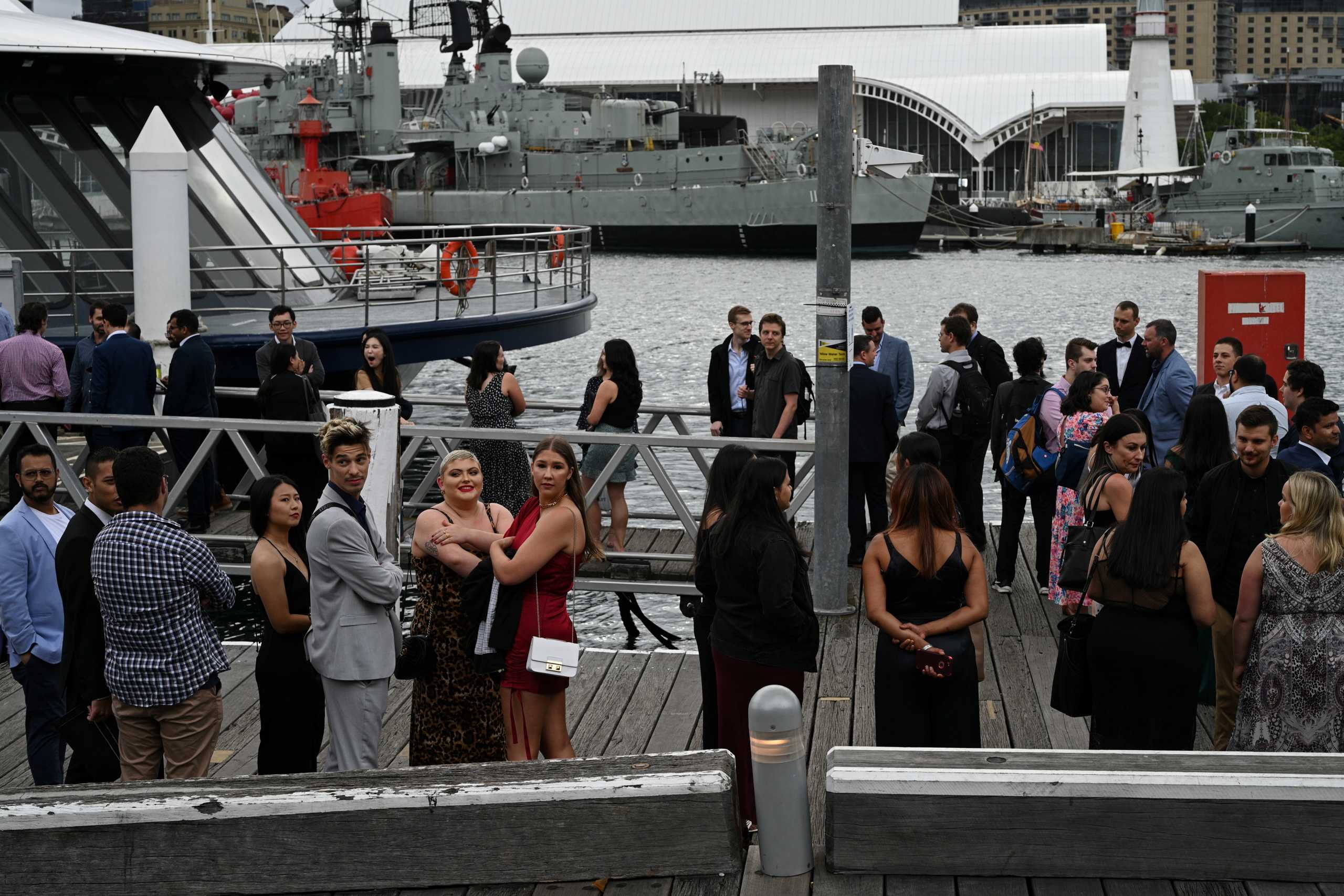 People wait to board a cruise boat at the city centre's waterfront following further easing of coronavirus disease (COVID-19) restrictions in Sydney, Australia, December 10, 2020.  REUTERS