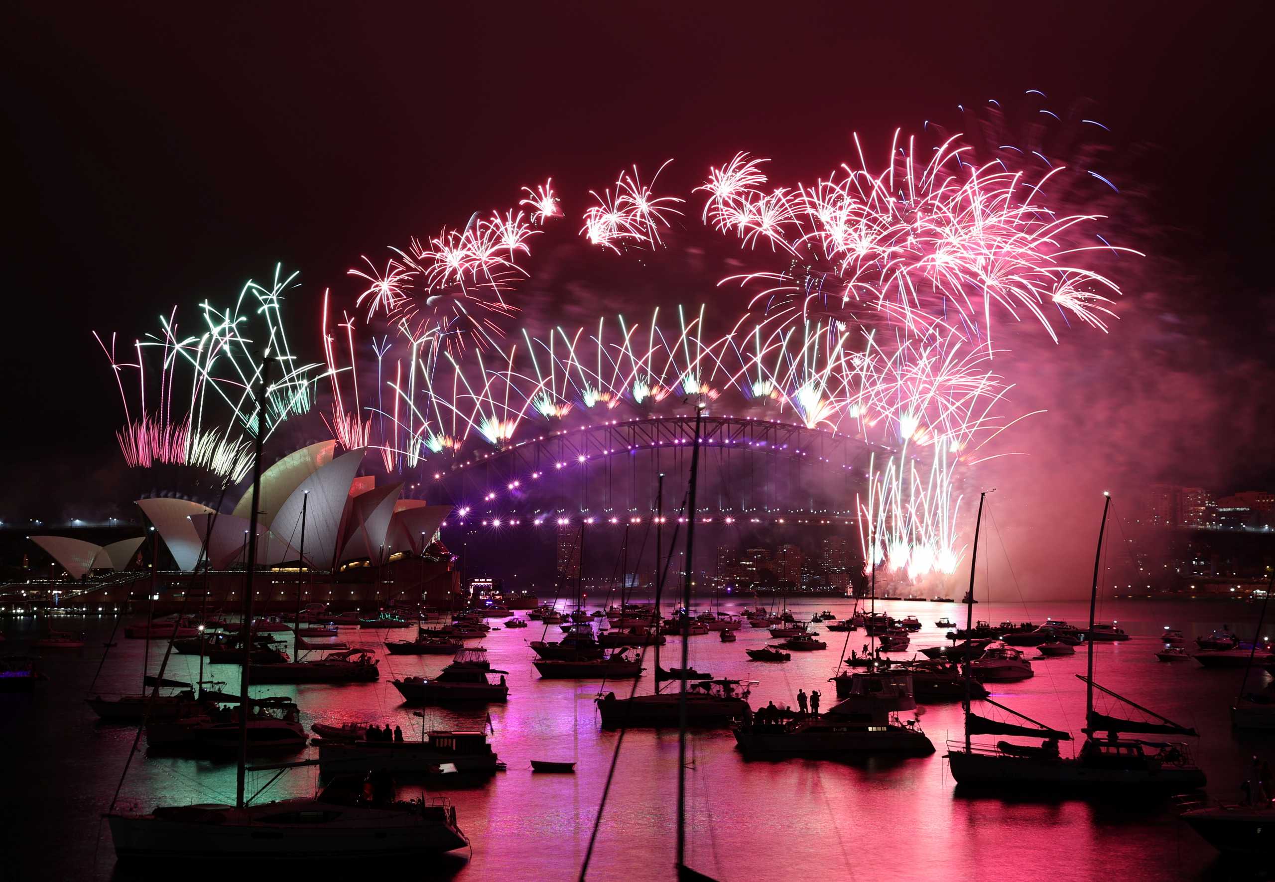 Fireworks explode over the Sydney Opera House and Sydney Harbour Bridge during downsized New Year's Eve celebrations due to an outbreak of the coronavirus disease (COVID-19) in Sydney, Australia, January 1, 2021. REUTERS
