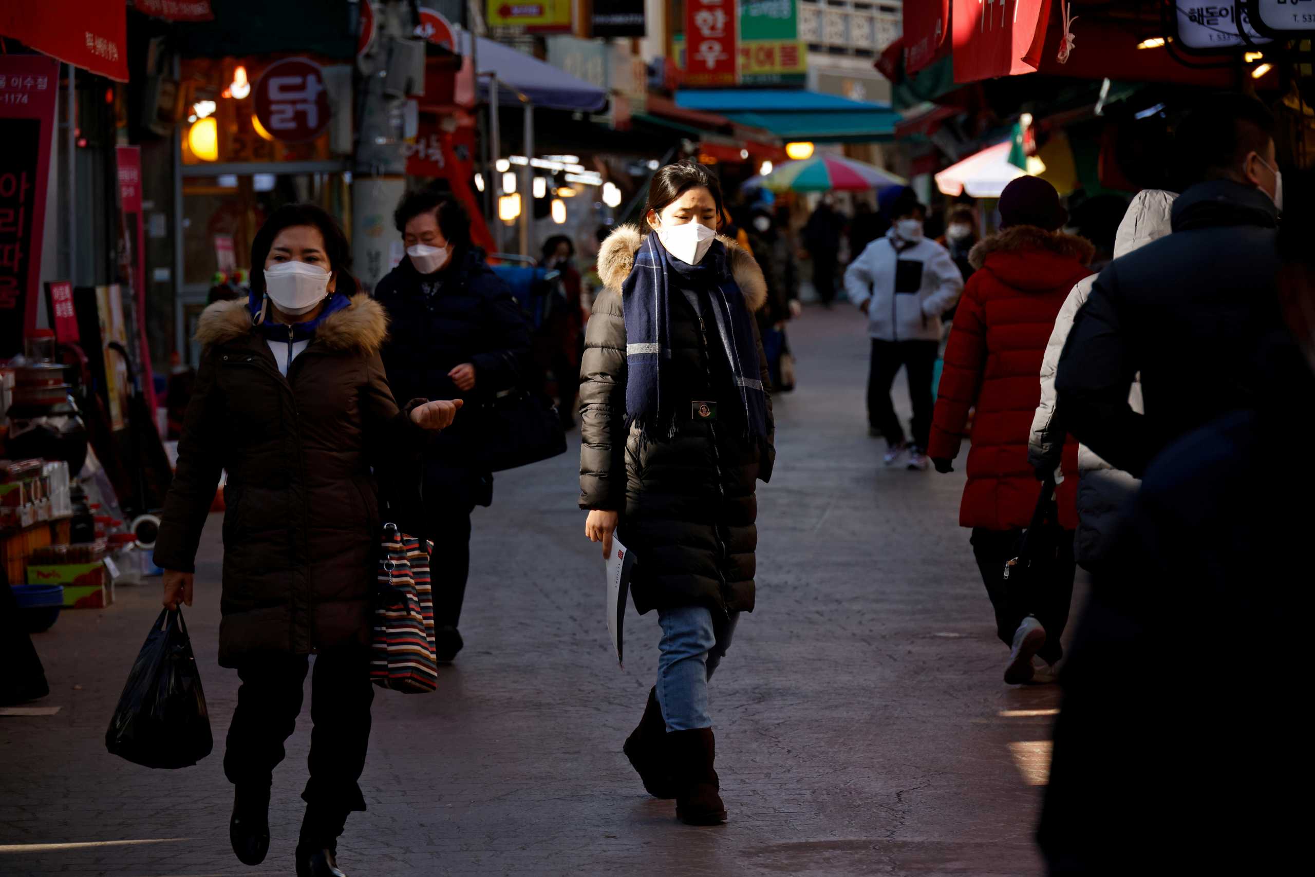 FILE PHOTO: People shop amid the coronavirus disease (COVID-19) pandemic at a traditional market in Seoul, South Korea, December 8, 2020.    REUTERS