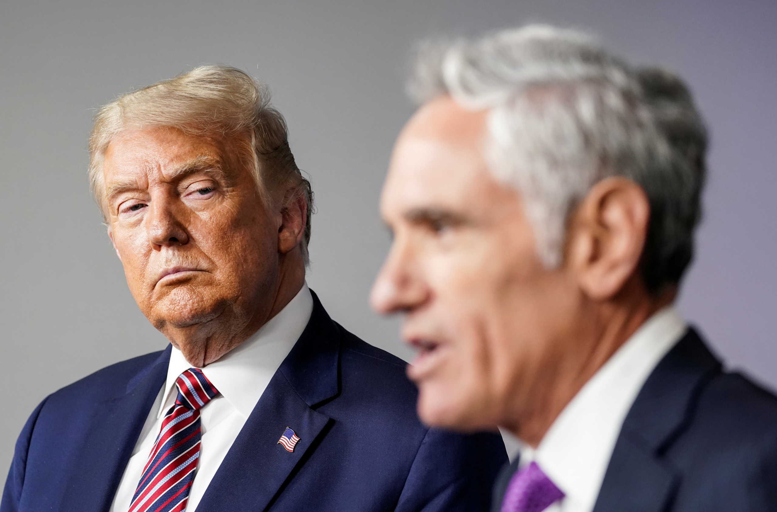 FILE PHOTO: U.S. President Donald Trump listens as Dr. Scott Atlas, the newest member of the administration's coronavirus task force, speaks during a briefing on the coronavirus disease (COVID-19) pandemic response at the White House in Washington, U.S., August 12, 2020. REUTERS