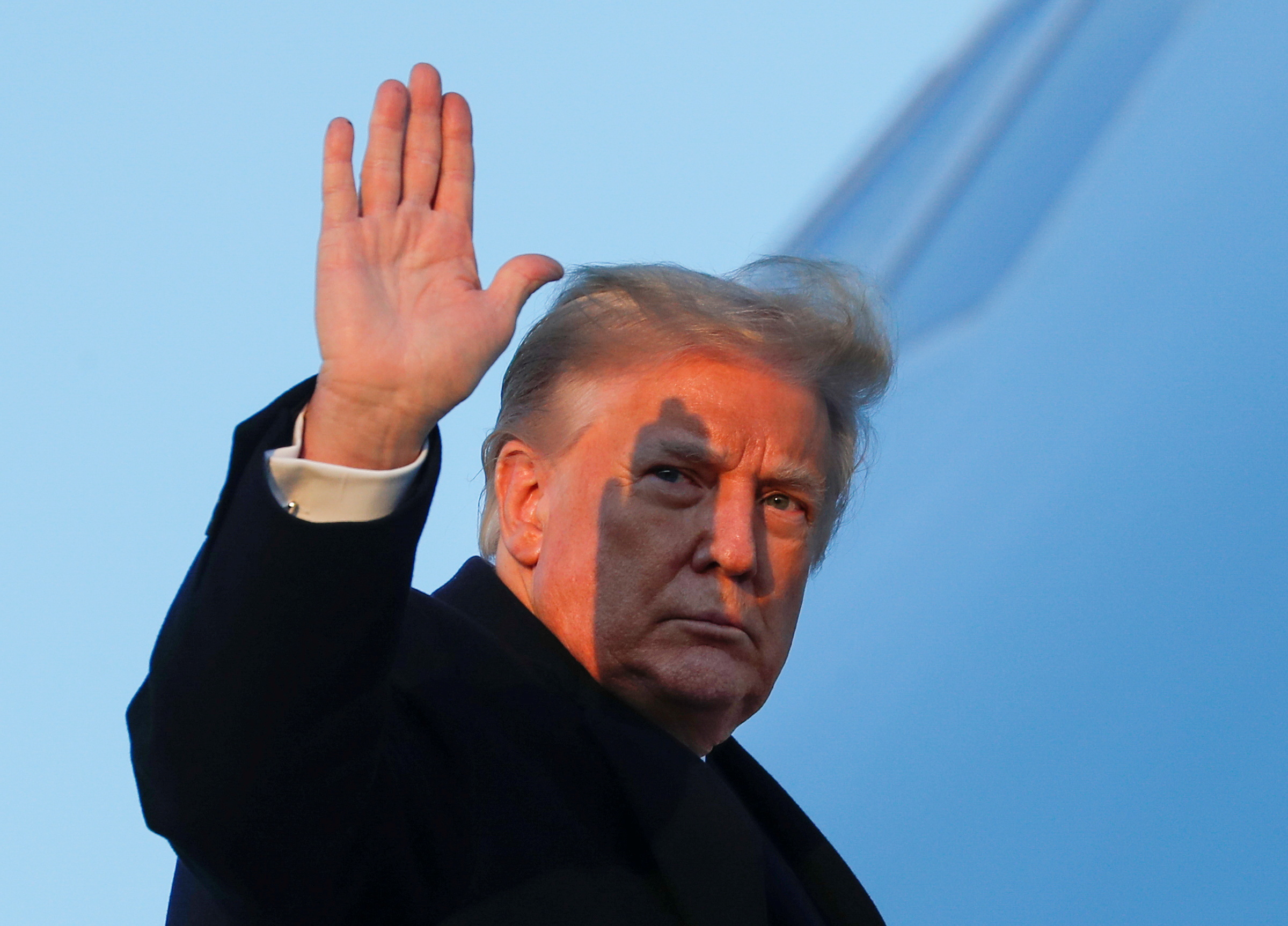U.S. President Donald Trump waves as he boards Air Force One at Joint Base Andrews in Maryland, U.S., December 23, 2020. REUTERS