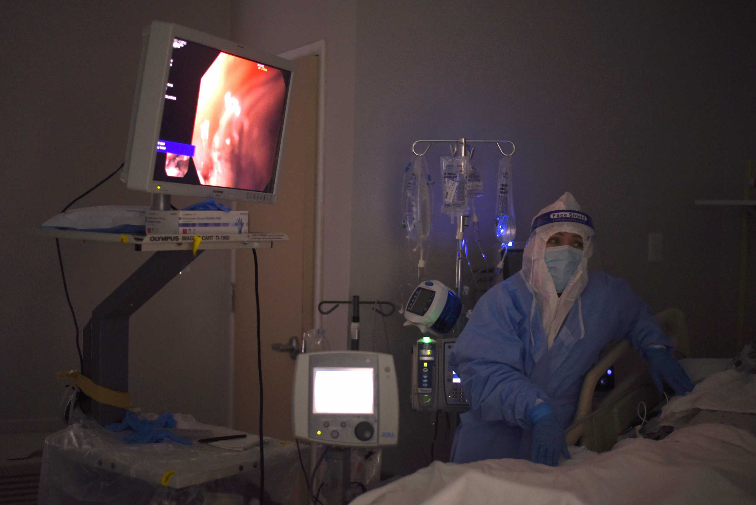 A healthcare worker helps as an endoscopy is performed on a patient infected with the coronavirus disease (COVID-19) at United Memorial Medical Center in Houston, Texas, U.S., December 29, 2020.  REUTERS