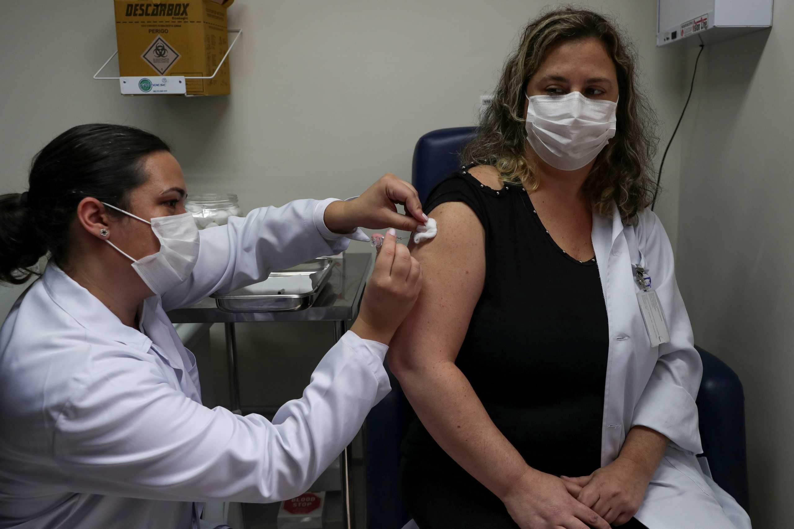 FILE PHOTO: A nurse administers CoronaVac, a Sinovac's potential vaccine against the coronavirus disease (COVID-19), to a volunteer and nurse Sarah Rangon at Emilio Ribas Institute in Sao Paulo, Brazil July 30, 2020. Picture taken July 30, 2020. REUTERS