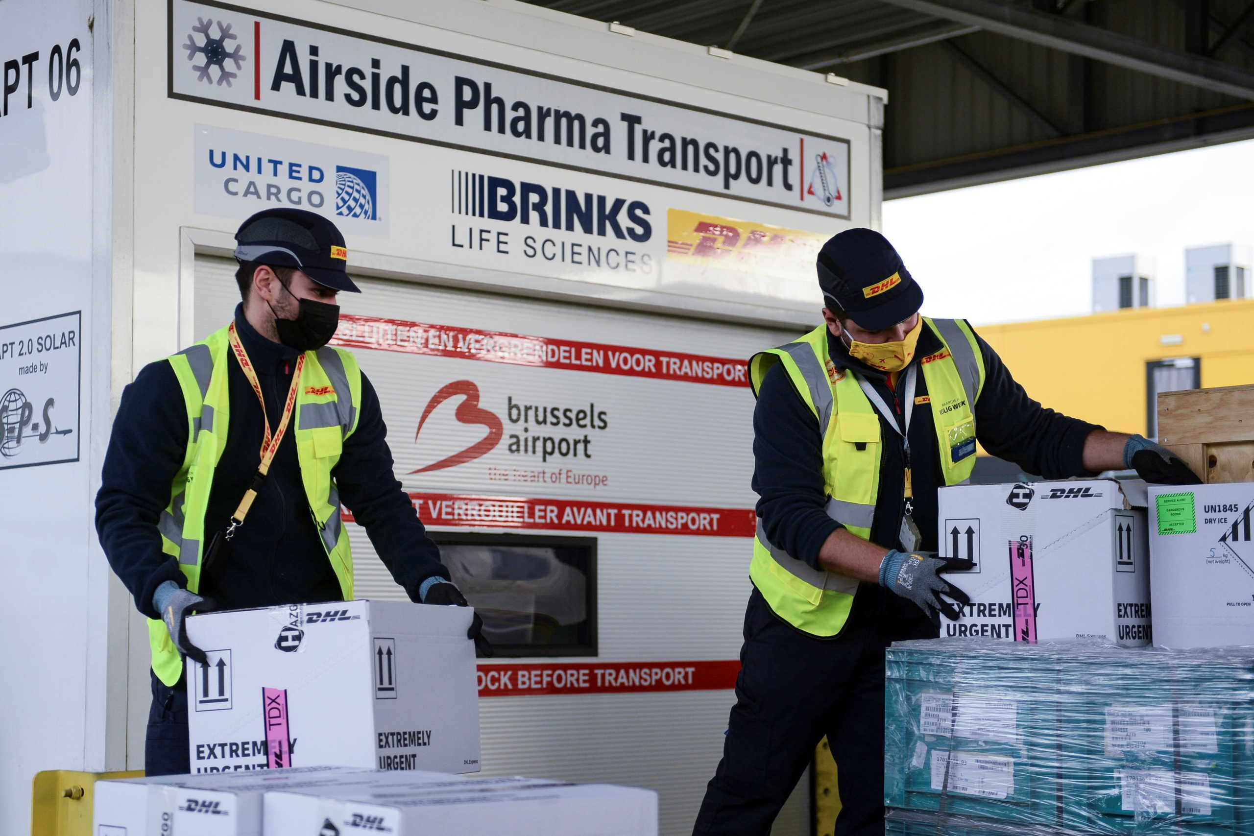Workers prepare cool boxes to be transported by an airplane as Brussels International Airport and its partners prepare a massive logistic operation of carrying new vaccines and vaccine candidates for the coronavirus disease (COVID-19) through Brussels International Airport, in Brussels, Belgium, December 1, 2020. REUTERS